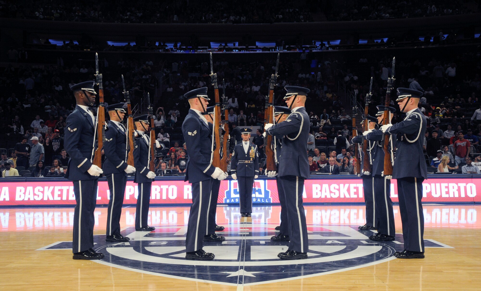 The United Stated Air Force Honor Guard Drill Team prepares to hurl their weapons during a halftime performance at the USA Men’s National Basketball Team game against Puerto Rico at Madison Square Garden, New York, August 22, 2014. The Drill Team promotes the Air Force mission by showcasing drill performances at public and military venues to recruit, retain and inspire Airmen. (U.S. Air Force photo/Airman 1st Class Ryan J. Sonnier)