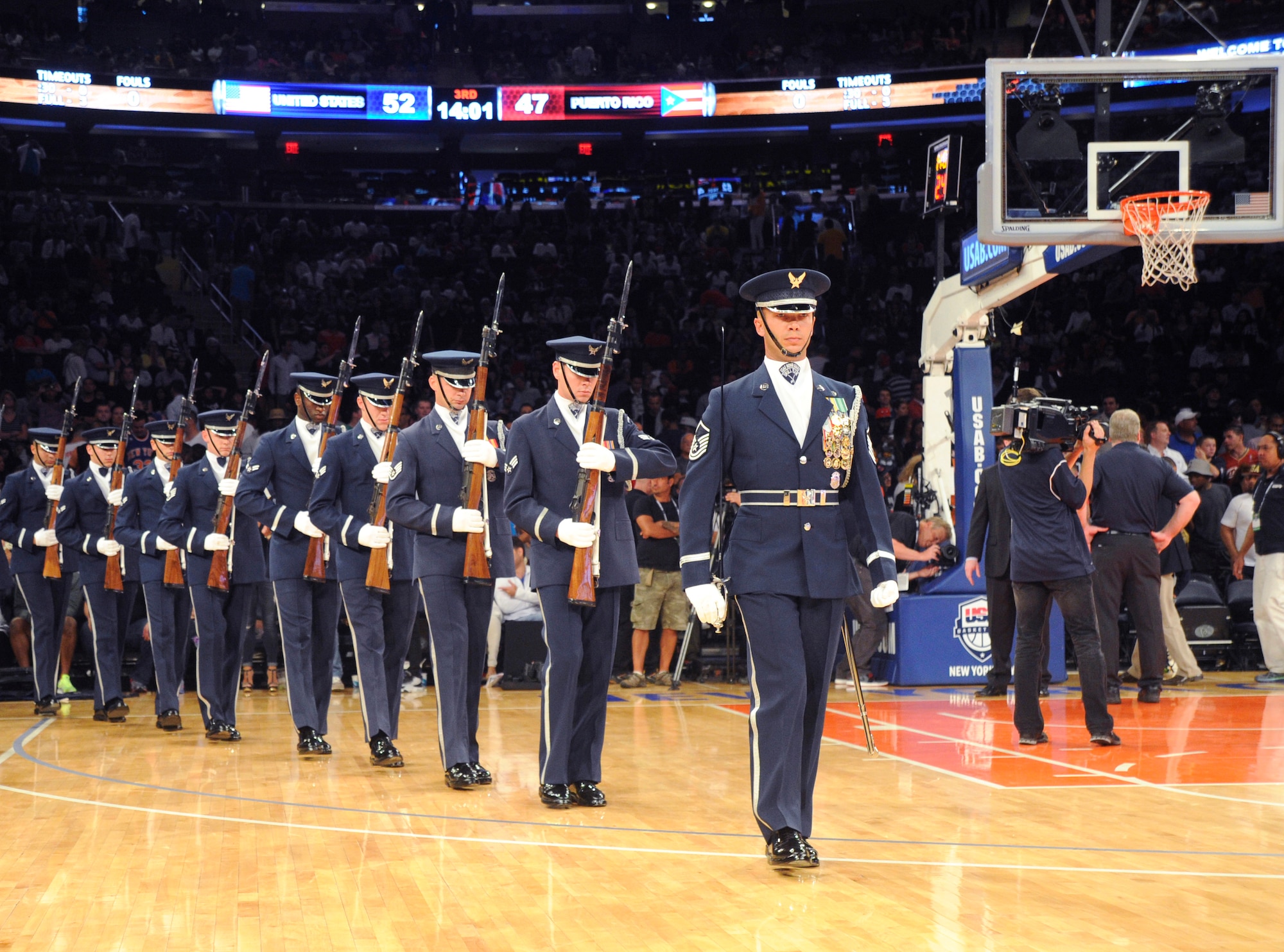 The United States Air Force Honor Guard Drill Team enters the court during halftime at the USA Men’s National Basketball Team game against Puerto Rico at Madison Square Garden, New York, August 22, 2014. The Drill Team promotes the Air Force mission by showcasing drill performances at public and military venues to recruit, retain and inspire Airmen.  (U.S. Air Force photo/Airman 1st Class Ryan J. Sonnier)