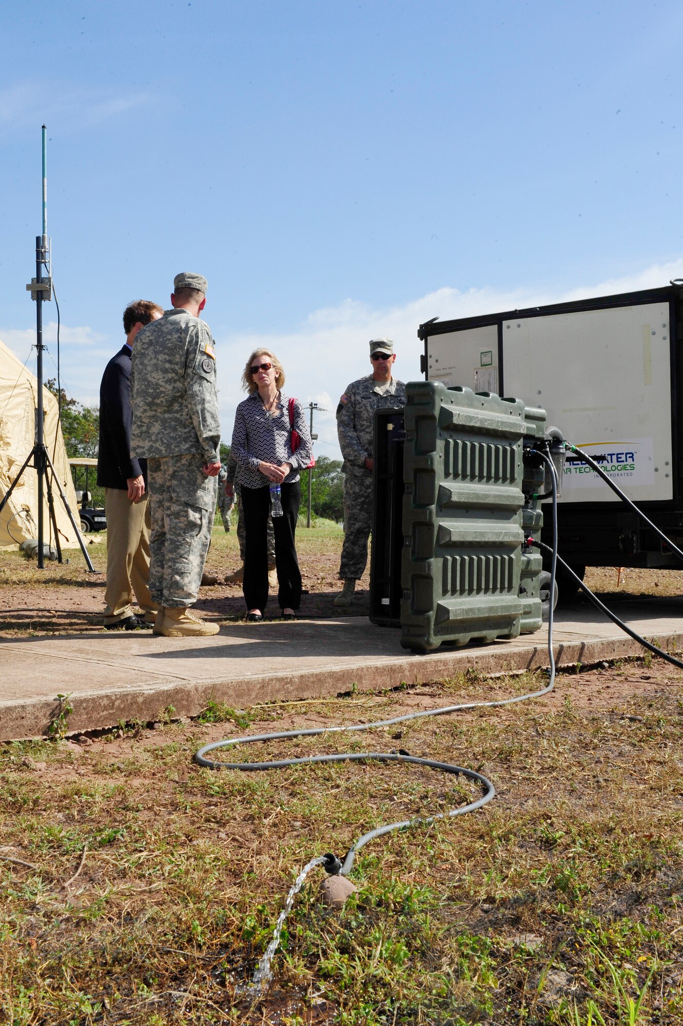 Ambassador James Nealon learns how water is purified in the Pre-Positioned Expeditionary Assistance Kit (PEAK) that's deployed by Army Forces Battalion for disaster relief missions during his first visit to Soto Cano Air Base, Honduras Aug. 25, 2014.  Ambassador Nealon recently arrived in Honduras Aug. 13, 2014 as the new U.S. Ambassador to the Republic of Honduras and most recently served as the Civilian Deputy to the Commander of U.S. Southern Command from Sept. 2013 to Aug. 2014.  (Photo by Martin Chahin)