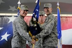 Brig. Gen. Bob LaBrutta (left), 502nd Air Base Wing and Joint Base San Antonio commander, passes the guidon to Col. Michael Gimbrone, incoming 502nd Security Forces and Logistics Support Group commander, Aug. 26, 2014 at JBSA-Randolph Hangar 73. As the 502nd SFLSG commander, Gimbrone will oversee the 502nd Security Forces Squadron, 802nd SFS, 902nd SFS, 502nd Logistics Readiness Squadron and 502nd Trainer Development Squadron. Gimbrone most recently served as deputy chief of the Force Protection Division and chief of the Asset Protection Branch in the Joint Staff Force Structure, Resources and Assessment Directorate at the Pentagon. (U.S. Air Force photo by Desiree Pilacios)