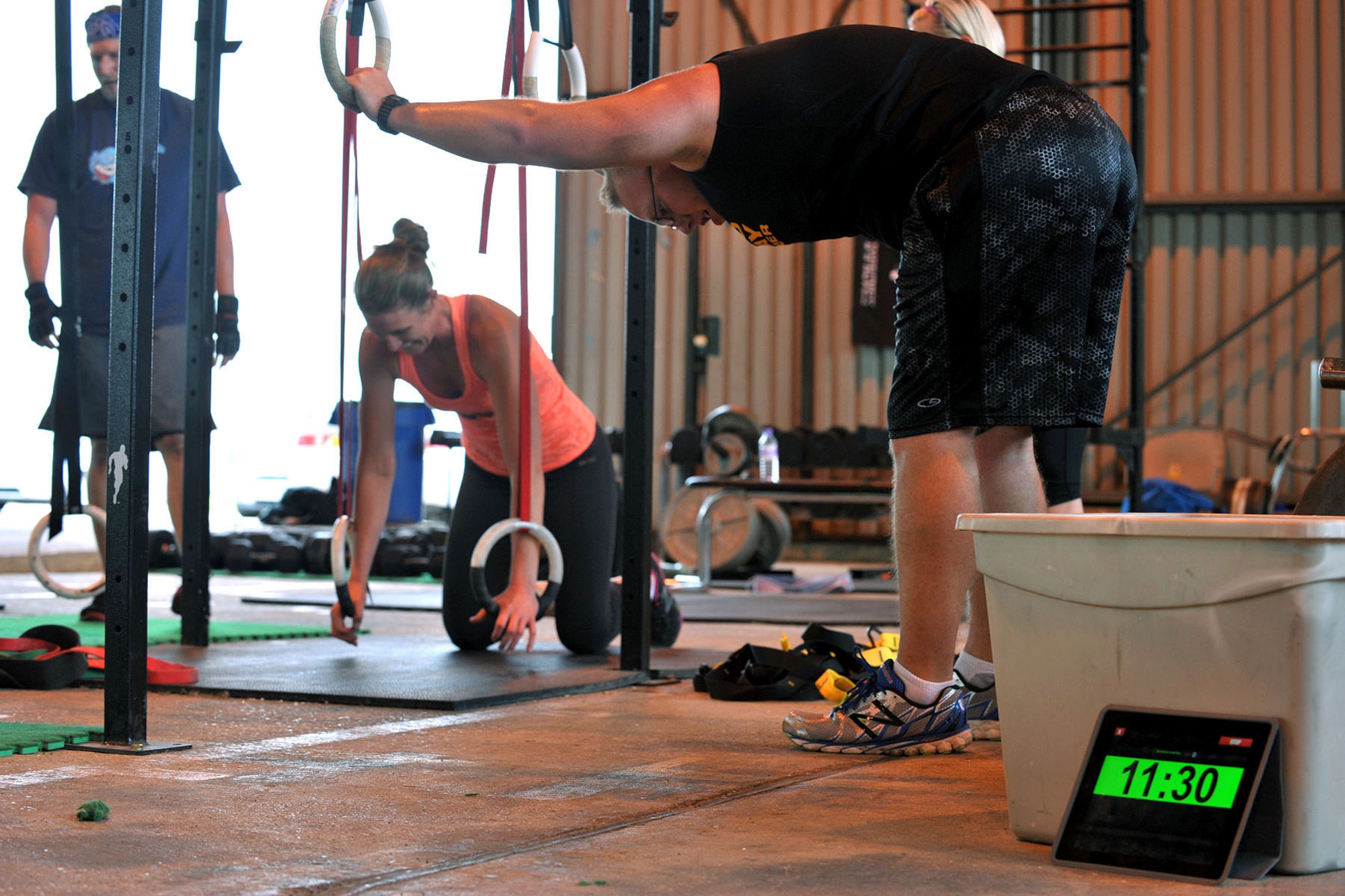 Members of CrossFit Molesworth perform ring push-ups during the Coe Hero workout of the day at RAF Molesworth, Aug. 14, 2014.  The Coe Hero WOD, which was held to honor U.S. Army Sgt. Keith Adam Coe, was a combination of 10 ring push-ups and 10 thrusters all in 10 rounds for time. (U.S. Air Force photo by Staff Sgt. Ashley Hawkins/Released)