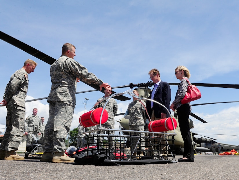 Ambassador James Nealon learns about the medical evacuation mission of the 1-228th Aviation Regiment during his first visit to Soto Cano Air Base, Honduras Aug. 25, 2014.  Ambassador Nealon recently arrived in Honduras Aug. 13, 2014 as the new U.S. Ambassador to the Republic of Honduras and most recently served as the Civilian Deputy to the Commander of U.S. Southern Command from Sept. 2013 to Aug. 2014.  (Photo by Martin Chahin)