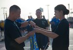 Col. Michelle Edmondson (right), 737th Training Group commander, and Chief Master Sgt. Richard Sutherland (left), 737th TRG superintendent,attach the top physical fitness flight marker to the 331st Training Squadron guidon prior to the Airman’s run July 3 at Joint Base San Antonio-Lackland.(U.S. Air Force photo by Benjamin Faske/Released)