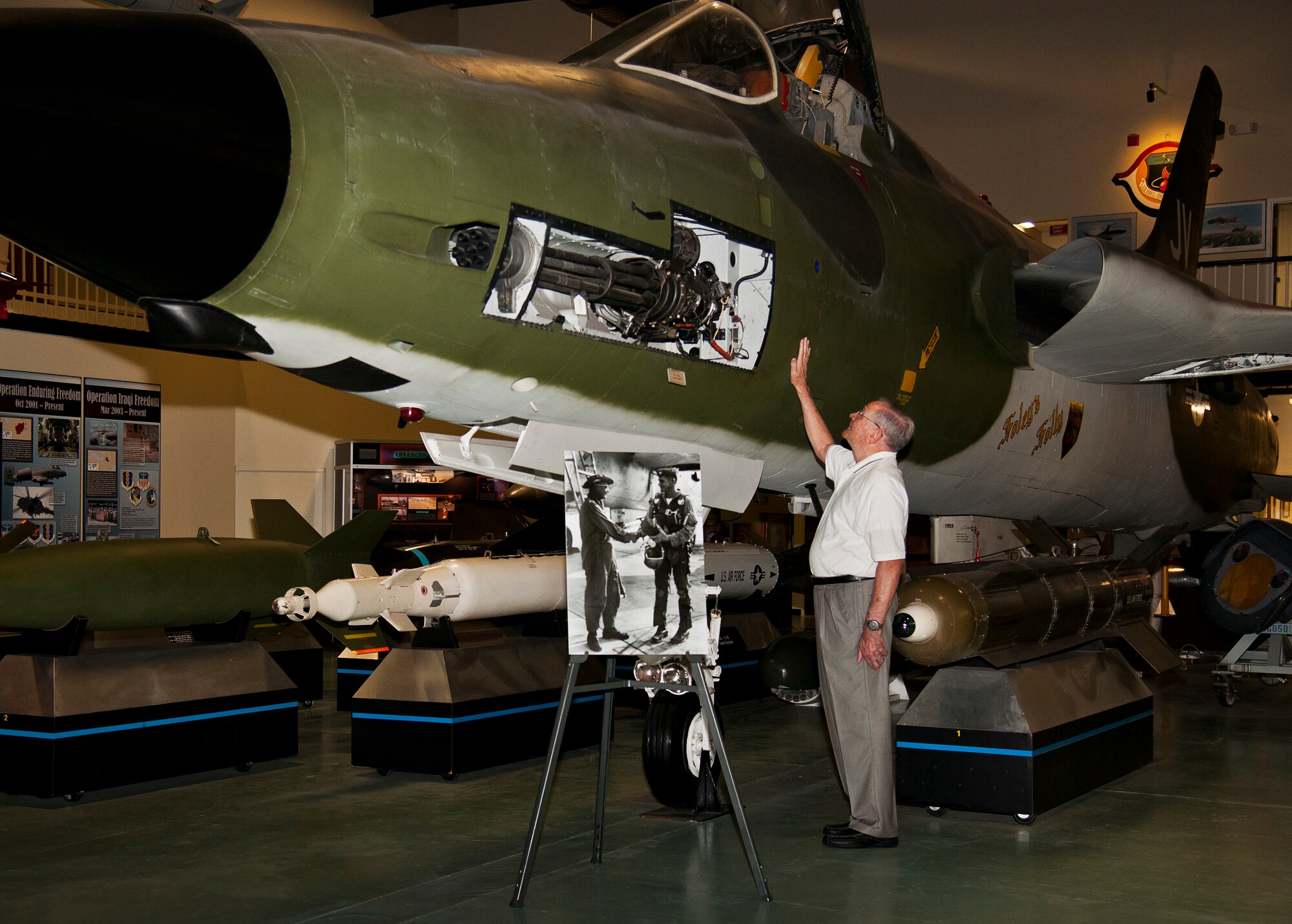 Retired Col. Stan Lockley shares a moment with his former aircraft, the F-105 Thunderchief, at the Air Force Armament Museum Aug. 26.  The 86th-year-old Lockley, a former vice commander of both the 33rd (Tactical) Fighter Wing and the 96th Test Wing, was one of the first Air Force pilots to complete 100 combat missions over North Vietnam.  (U.S. Air Force photo/Samuel King Jr.)