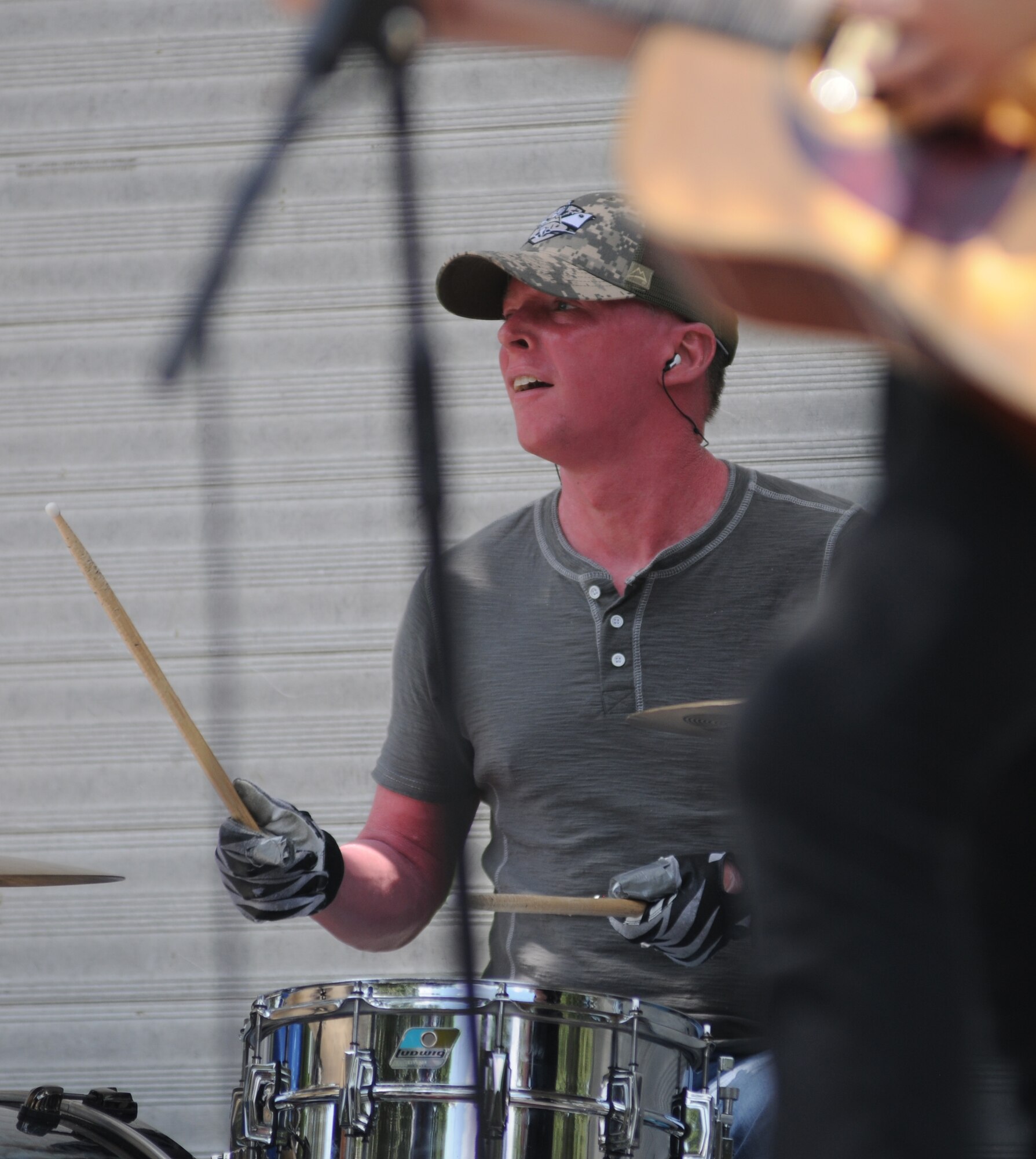 Mason Holland, drummer for the Derek Norsworthy band, performs during the BBQ on the Bay event Aug. 23, 2014, at the Marina Park, Keesler Air Force Base, Miss.  BBQ plates were sold and a Mullet toss competition also took place.  (U.S. Air Force photo by Kemberly Groue)