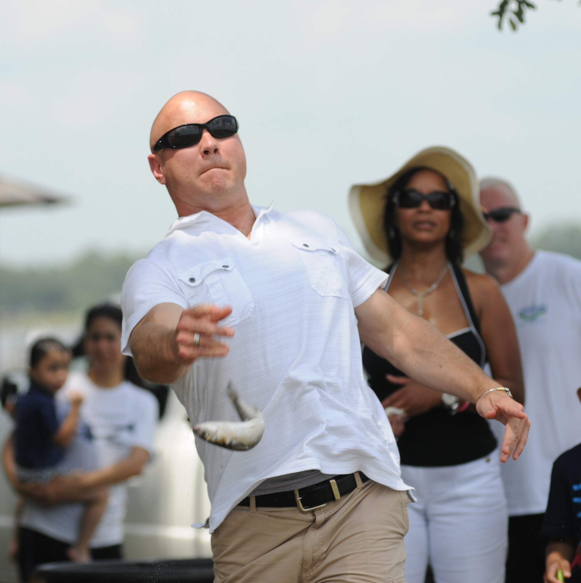 Master Sgt. Ed Scherzer, 53rd Weather Reconnaissance Squadron,  participates in the Mullet toss competition during the BBQ on the Bay event Aug. 23, 2014, at the Marina Park, Keesler Air Force Base, Miss.  Entertainment also included live music and BBQ.  (U.S. Air Force photo by Kemberly Groue)