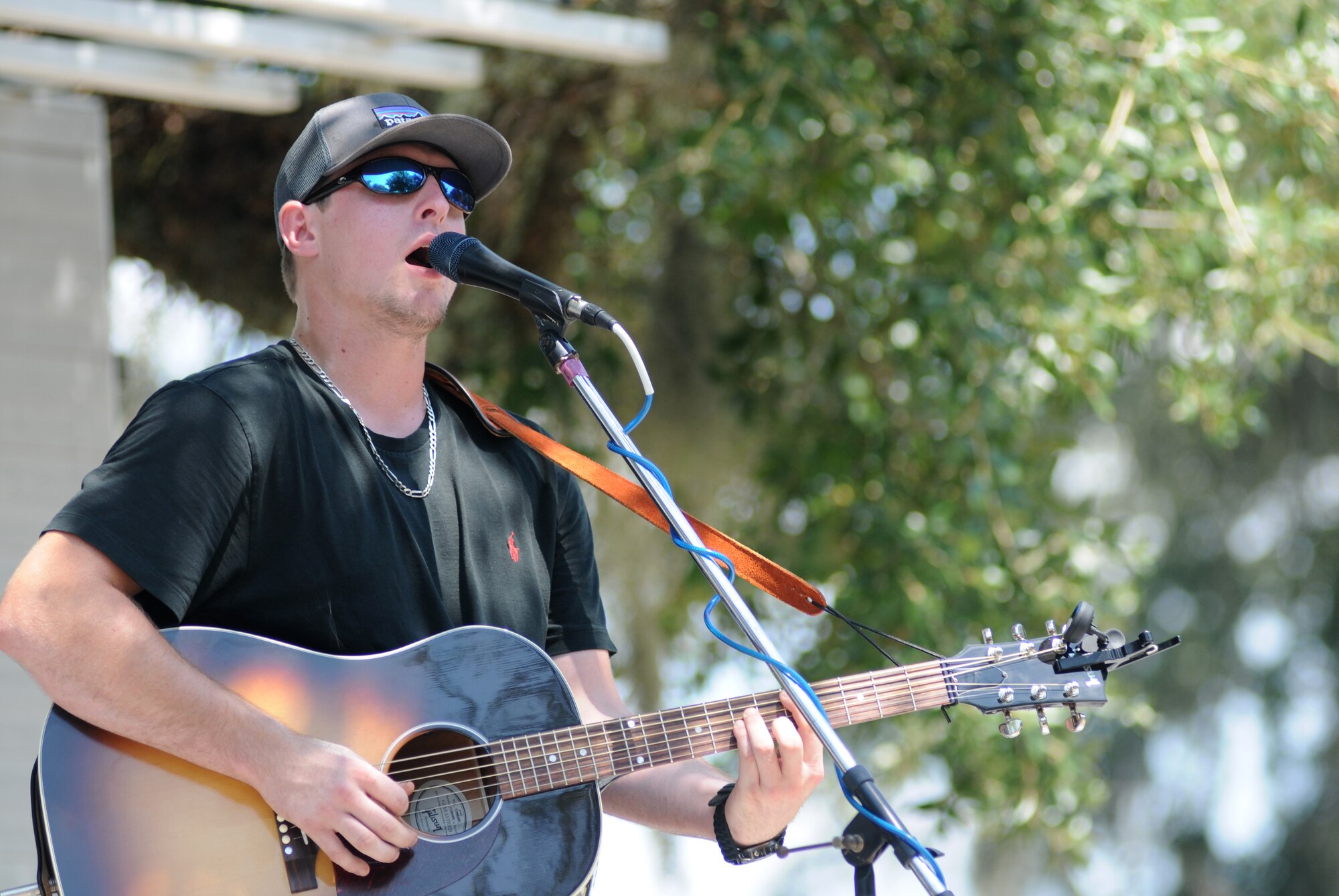 Cole Jones performs during the BBQ on the Bay event Aug. 23, 2014, at the Marina Park, Keesler Air Force Base, Miss.  BBQ plates were sold and a Mullet toss competition also took place.  (U.S. Air Force photo by Kemberly Groue)