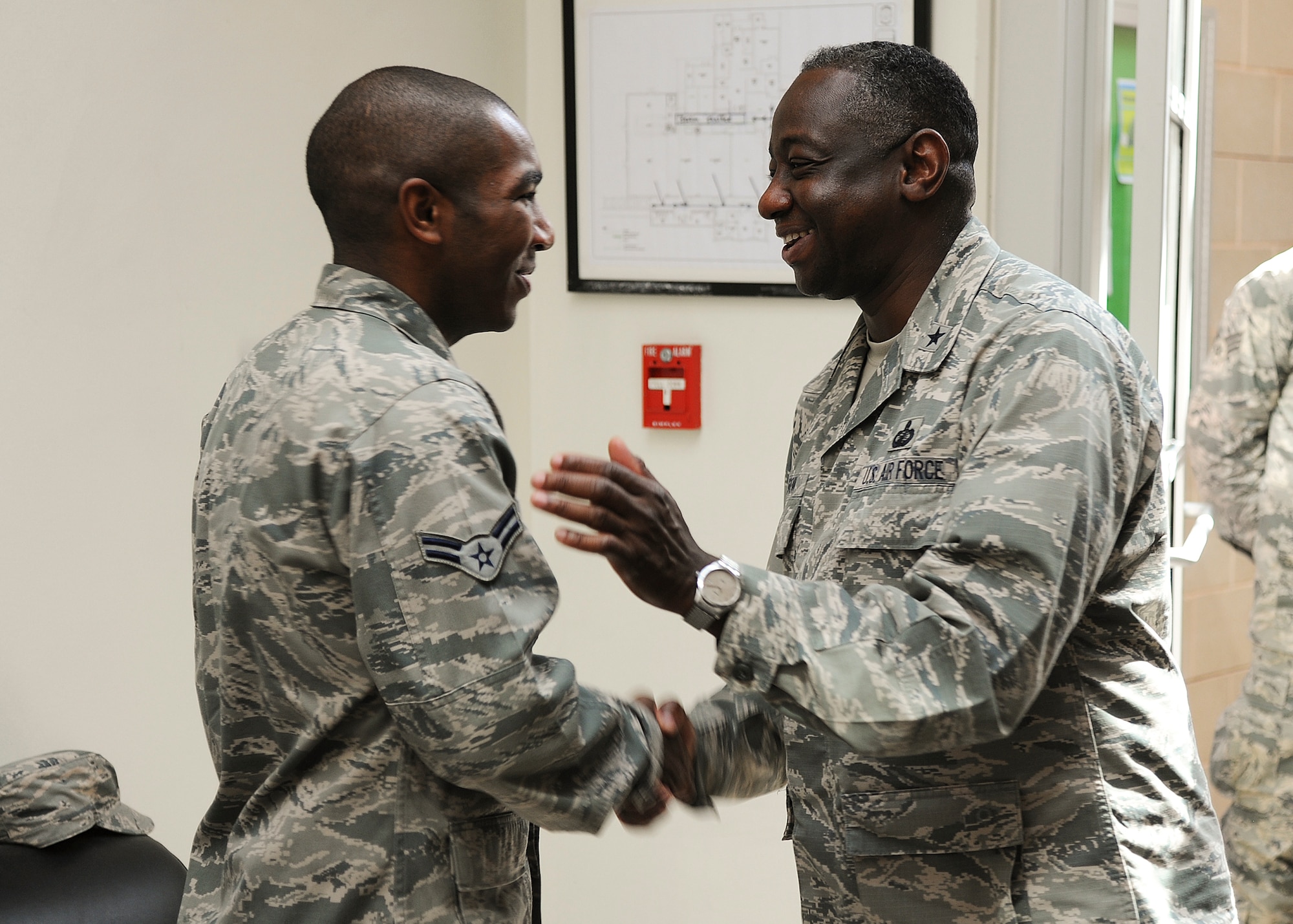GOODFELLOW AIR FORCE BASE, Texas -- Brig. Gen. Mark Brown, Second Air Force Commander, presents Airman 1st Class Darrin T. Davis, 17th Contracting Squadron contract specialist, with a commander’s coin at the Event Center Aug 22. Davis said it was an honor to receive the coin from Gen. Brown. (U.S. Air Force Photo/ Airman 1st Class Devin Boyer)