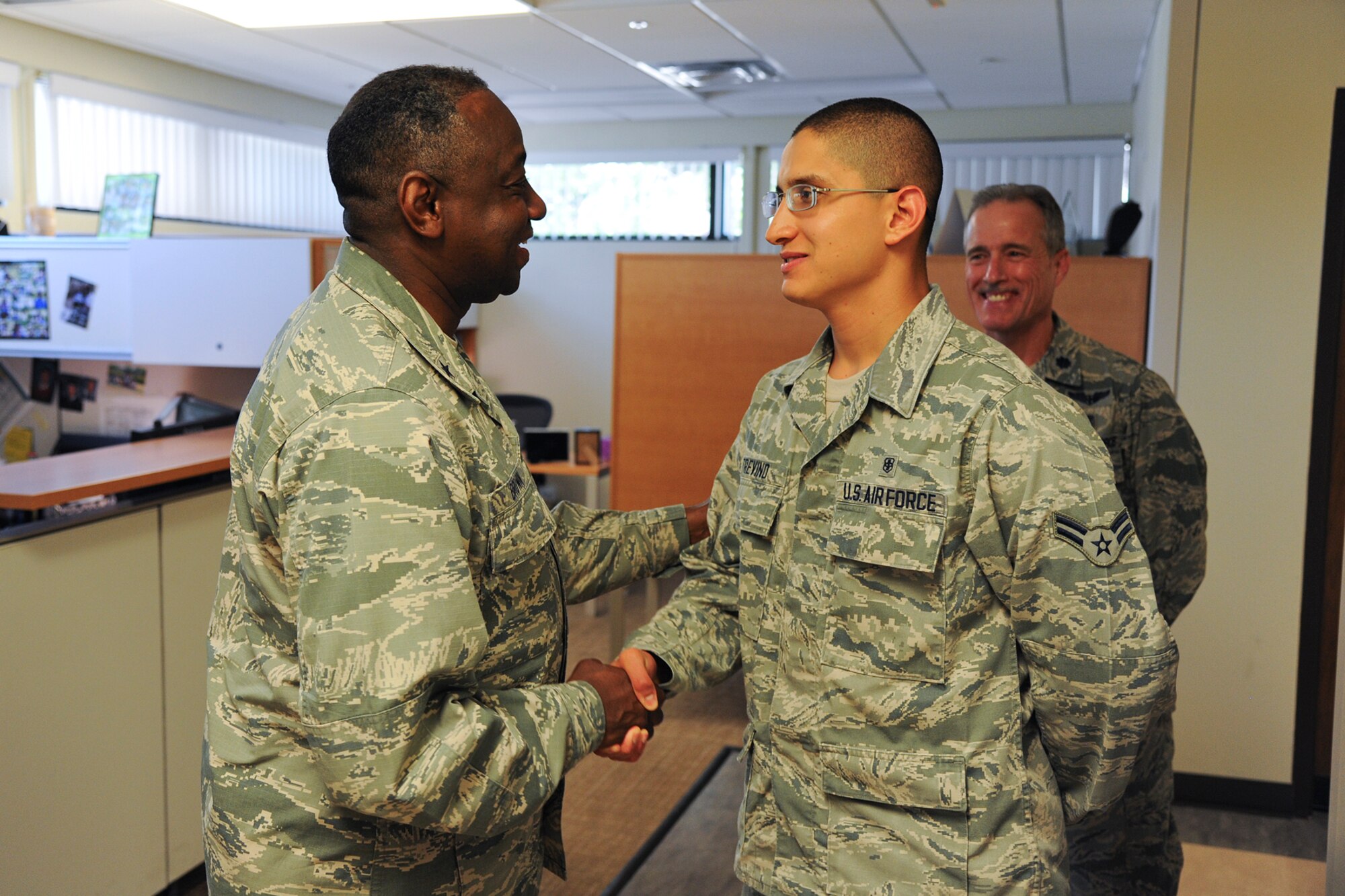 GOODFELLOW AIR FORCE BASE, Texas – Brig. Gen. Mark Brown, Second Air Force Commander, presents Airman 1st Class Alberto N. Trevino Jr., 17th Medical Operations Squadron aerospace medical service apprentice, with a commanders coin at the Ross Clinic Aug. 20. Trevino finished his career development course six months early and scored a 96 percent on his end of course exam. (U.S. Air Force photo/ Airman 1st Class Devin Boyer)
