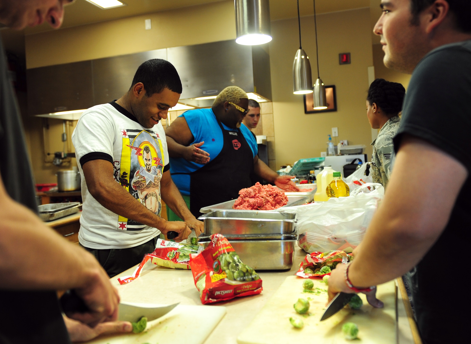 Airmen from the 7th Security Forces Squadron help Willie Mike, MasterChef competitor, prepare a meal Aug. 15, 2014, at Dyess Air Force Base, Texas. Willie came to Dyess after Senior Airman Nicholas Navarro, 7th SFS force response leader, contacted him on Twitter to ask if he would like to help boost morale by cooking for Dyess’ first responders. (U.S. Air Force photo by Senior Airman Kia Atkins/Released)