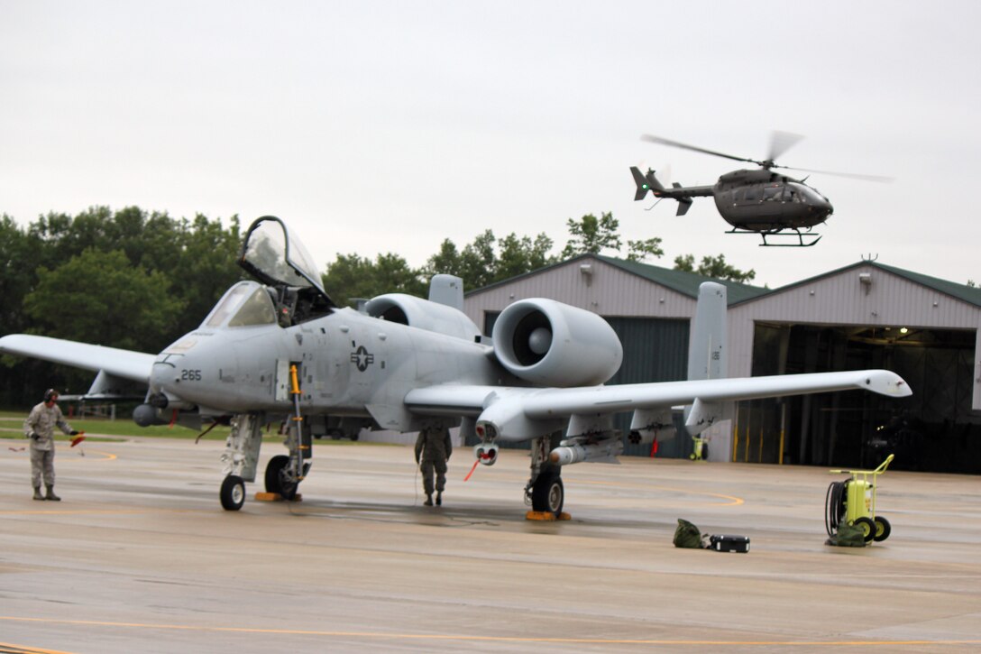 A Michigan Army National Guard UH-72 Lakota helicopter takes off near a Michigan Air National Guard A-10 Thunderbolt II during Operation Northern Strike at the Alpena Combat Readiness Training Center, Aug. 16, 2014. Twenty-four units from 12 States and two coalition partners will participate in the three-week event. Operation Northern Strike will occur from Aug. 4 - 22, 2014, at the Alpena Combat Readiness Training Center and Camp Grayling Joint Maneuver Training Center. Over 300 Total Force fighter, bomber, mobility and rotary sorties are planned in support of live fire exercises in order to meet stated objectives for participating units. (U.S. Air National Guard photo by Tech. Sgt. Dan Heaton)