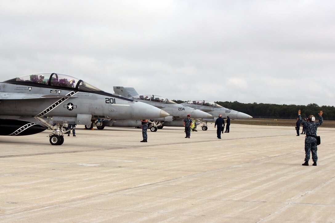 Sailors from VFA-103, Naval Air Station Oceana, Va., prepare to launch F/A-18 Super Hornets at the Alpena Combat Readiness Training Center during Operation Northern Strike, Aug. 18, 2014. Twenty-four units from 12 States and two Coalition partners will participate in the three-week event. Operation Northern Strike will occur from Aug. 4 - 22, 2014, at the Alpena Combat Readiness Training Center and Camp Grayling Joint Maneuver Training Center. Over 300 Total Force fighter, bomber, mobility, and rotary sorties are planned in support of live fire exercises in order to meet stated objectives for participating units. (U.S. Air National Guard photo by Tech. Sgt. Dan Heaton)