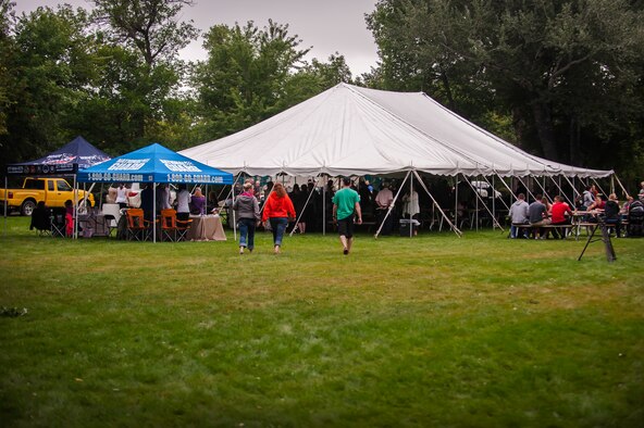 Airmen and their families from Minot Air Force Base conglomerate at a tent near Roosevelt Park Zoo in Minot N.D. Friday, Aug. 22. Military Appreciation Day at the zoo offered free food and admission for service members and their families. (U.S. Air Force photo/1st Lt. Jose R. Davis)