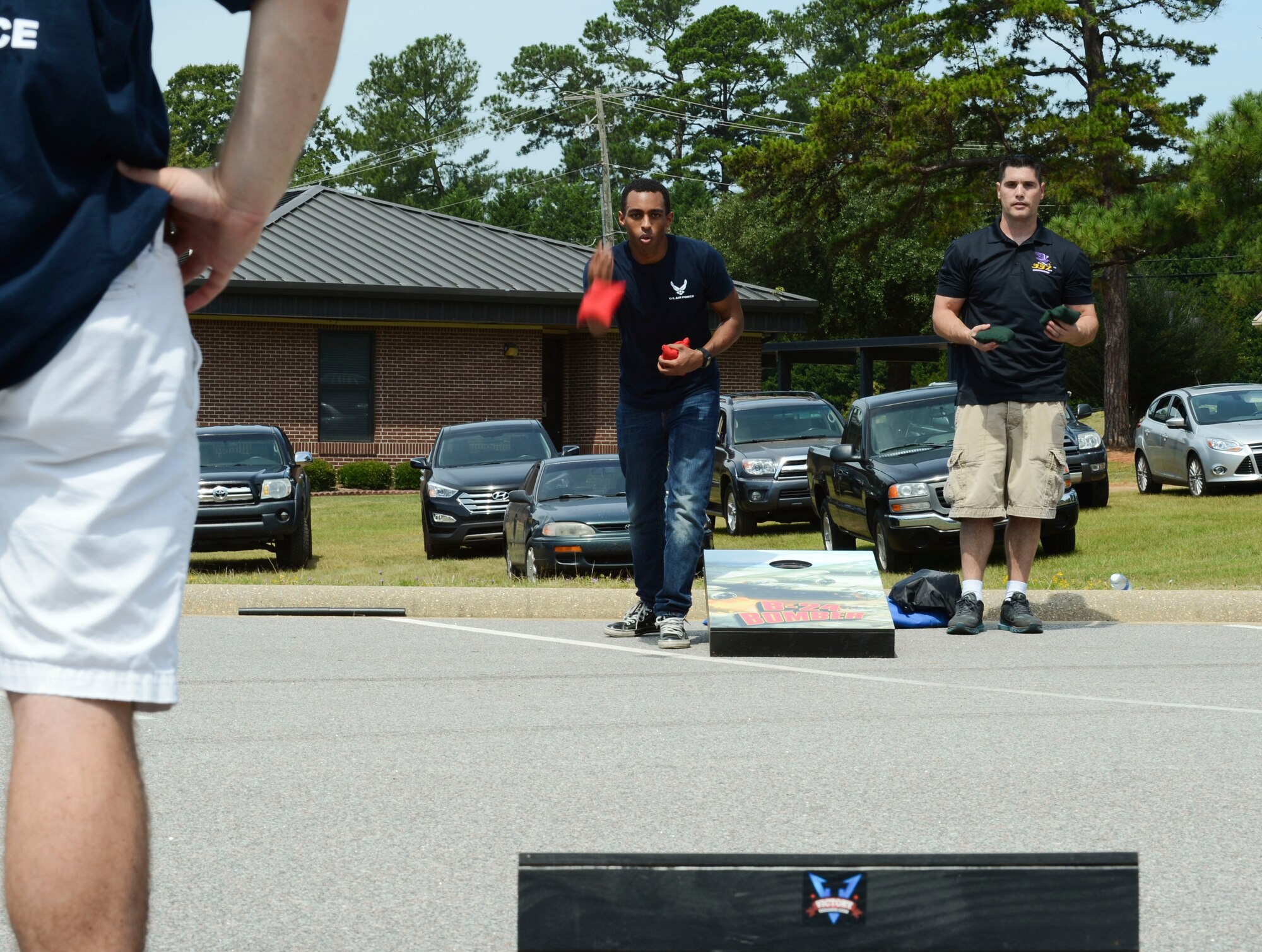 Andrew White and U.S. Air Force Tech. Sgt. Steven Dagnan, 337th Recruiting Squadron recruiter, play cornhole at Shaw Air Force Base, S.C., Aug. 22, 2014. Cornhole and other activities, were held at Shaw to recognize Airmen for all they do during Comprehensive Airman Fitness and Big “A” Appreciation Day. (U.S. Air Force photo by Senior Airman Tabatha Zarrella/Released)
