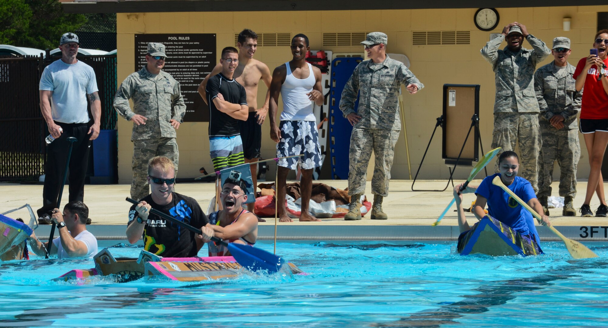 Members of Team Shaw participate in the cardboard regatta as part of Comprehensive Airman Fitness and Big “A” Appreciation Day at Shaw Air Force Base, S.C., Aug. 22, 2014. Each team built cardboard boats within specific guidelines and tested the durability by racing from one end of the Woodland pool and back. (U.S. Air Force photo by Senior Airman Tabatha Zarrella/Released)