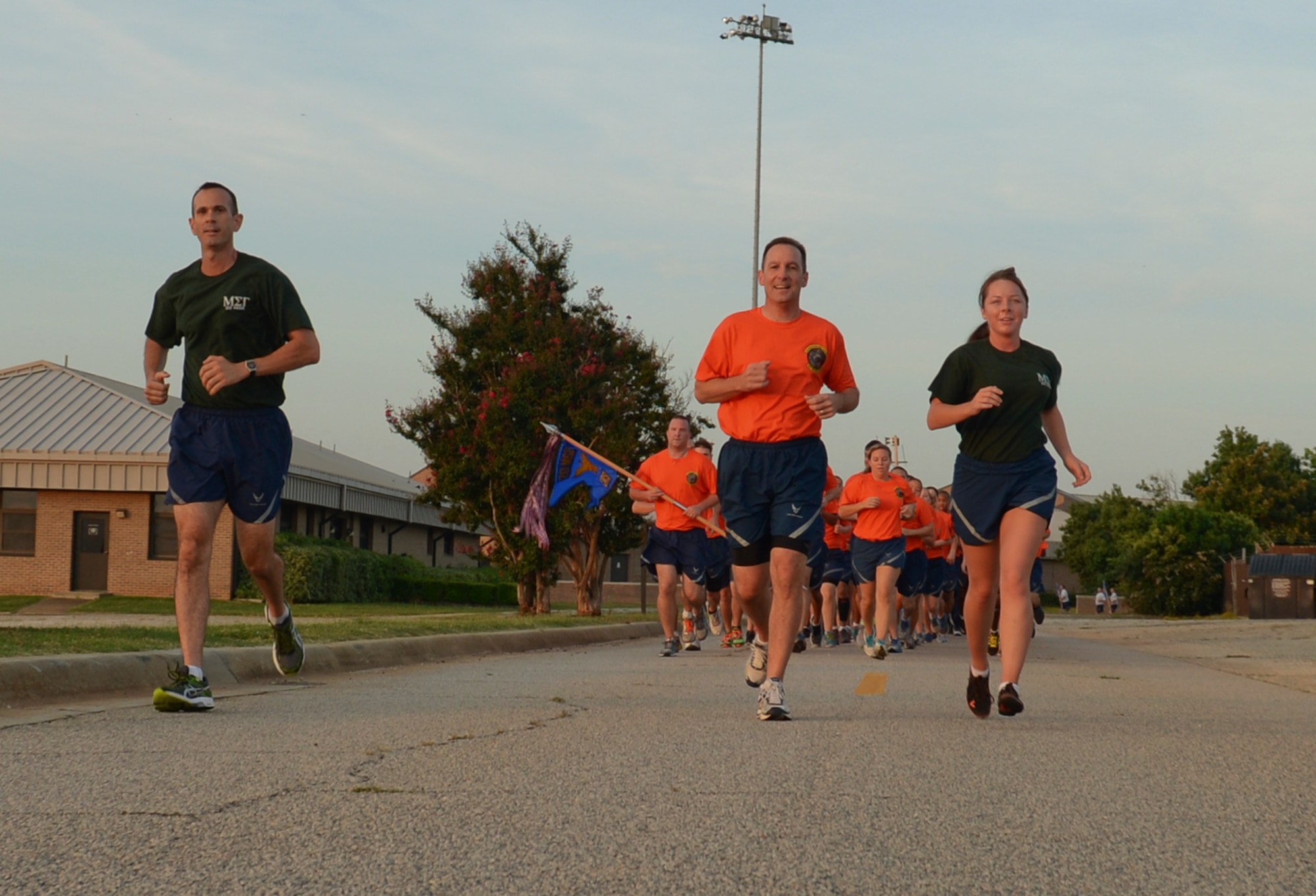 U.S. Air Force Col. Scott Arcuri (center), 20th Mission Support Group commander, leads a group of Airmen during a formation run at Shaw Air Force Base, S.C., Aug. 22, 2014. The formation run was part of Comprehensive Airman Fitness and Big “A” Appreciation Day, which was a combined day for Airmen to be recognized for their hard work. (U.S. Air Force photo by Senior Airman Tabatha Zarrella/Released)
