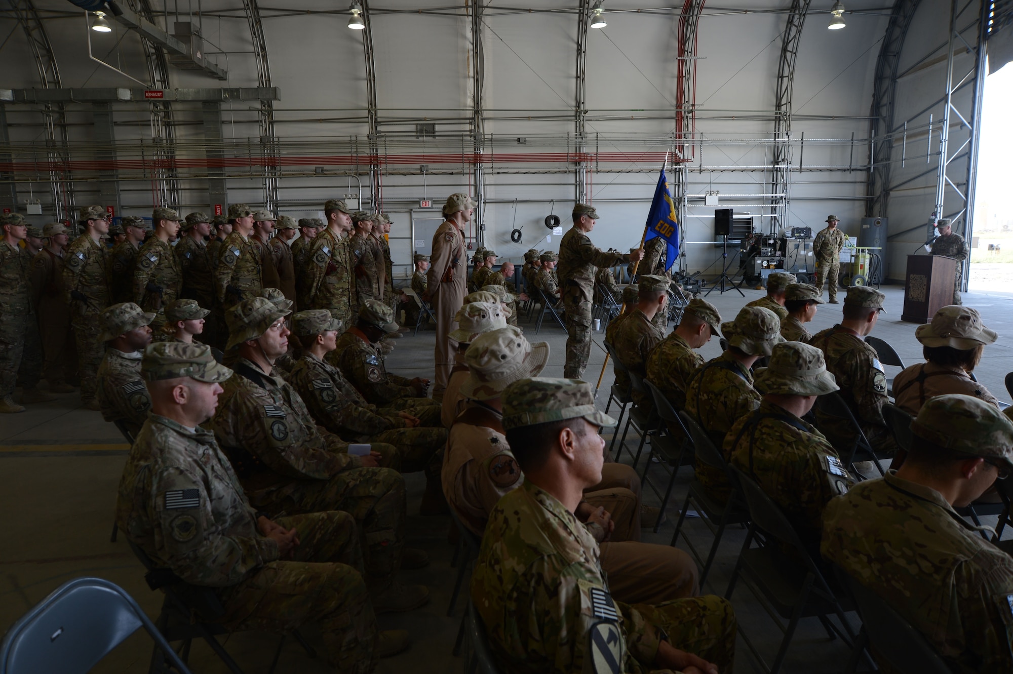 U.S. Air Force members gather to watch the 455th Expeditionary Operations Group Assumption of command at Bagram Airfield, Afghanistan Aug. 26, 2014. U.S. Air Force Col. Jon C. Wilkinson succeeded Col Robert S. Jobe, who left a few weeks earlier. Wilkinson will be responsible for all expeditionary flying and aeromedical evacuation operations for the 455th Air Expeditionary Wing. (U.S. Air Force photo by Master Sgt. Cohen A. Young/Released)
