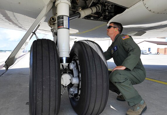 Maj. William Dabney, 86th Inspector General chief of wing readiness, does a routine inspection on a C-37A Gulfstream V before takeoff of a training on Aug. 11, 2014 at Ramstein Air Base, Germany. Dabney will be returning to the 76th Airlift Squadron after spending a year working for the Inspector General. (U.S. Air Force photo/Airman Larissa Greatwood)