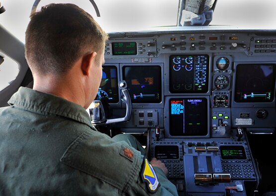 Maj. William Dabney, 86th Inspector General chief of wing readiness, sits in the pilot seat of a C-37A Gulfstream V checking to make sure everything is ready before a training flight on Aug. 11, 2014 at Ramstein Air Base, Germany. Dabney is an aircraft commander for the C-37A Gulfstream V and C-20H Gulfstream IV for the 76th Airlift Squadron here. (U.S. Air Force photo/Airman Larissa Greatwood)