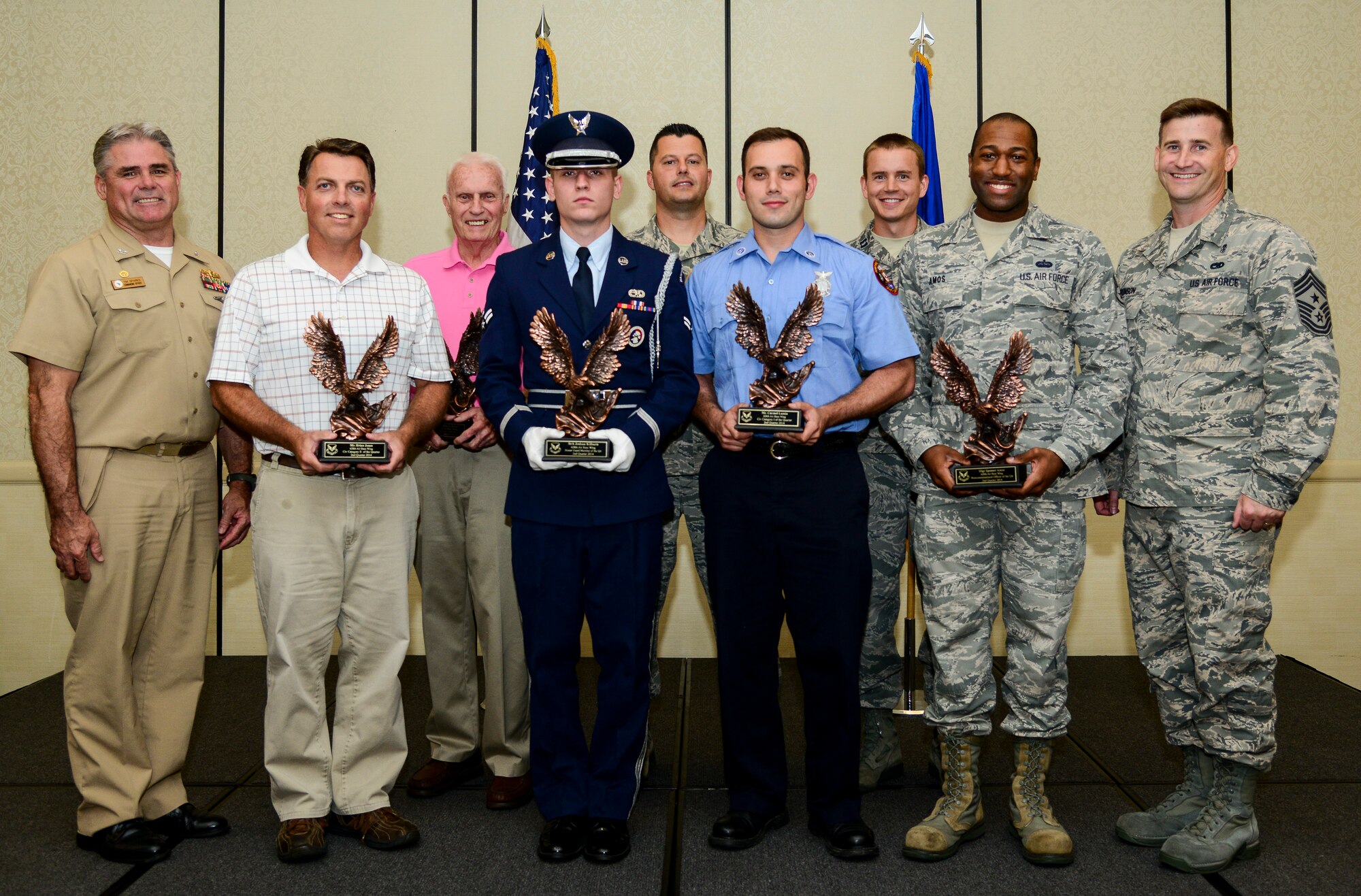 Capt. Timothy Sparks, Joint Base Charleston deupty commander (left), and Chief Master Sgt. Mark Bronson, 628th Air Base Wing command chief (right), congratulate (left to right) Brian Jones, Civilian Category II of the Quarter; Mr. Robert Hunt, Volunteer of the Quarter; Senior Airman Joshua Kilburn, Honor Guard Member of the Quarter;  Master Sgt. Ruebin Long, Senior Noncomissioned Officer in Charge of the Quarter; Carmel Lumia, Civilian Category I of the Quarter; Capt. Joshua Van Wyngaarden, Company Grade Officer of the Quarter; and Staff Sgt. Spenser Amos , Noncomissioned Officer of the Quarter Aug. 4, 2014, at the Charleston Club on JB Charleston. The Quarterly Awards are held to recognize outstanding Airmen, noncommisioned officers, senior noncomissioned officers, company grade officers and civilians for their hard work and dedication. (U.S. Air Force photo/Airman 1st Class Clayton Cupit)