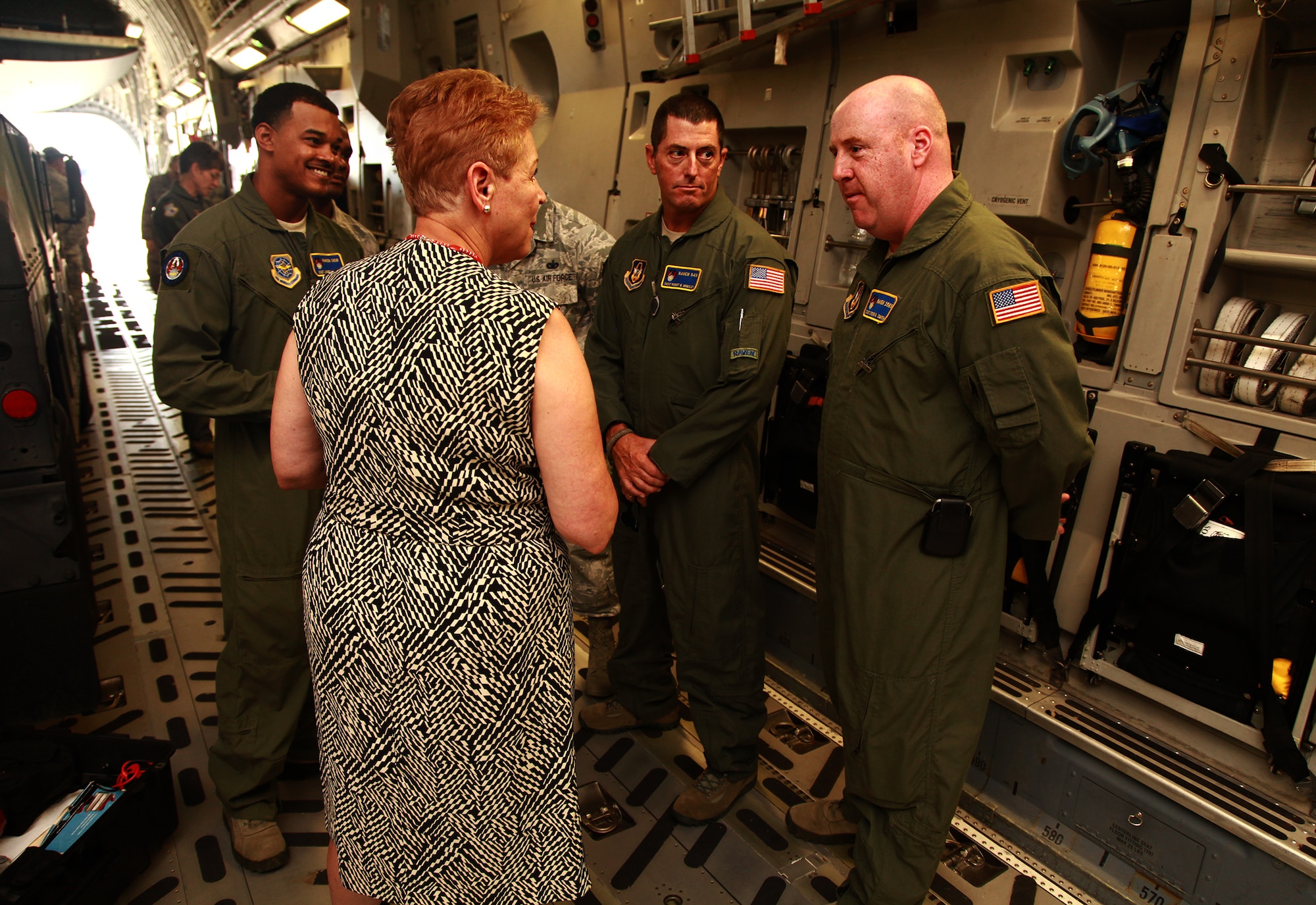 Chief Master Sgt. Rob Grimsley and Tech. Sgt. Steve Smith, both 315th Security Forces Squadron, describe the Ravens mission to Undersecretary of Defense for Personnel and Readiness Jessica Wright with Dr. (Lt. Col.) Frederick Huiet, 315th Aerospace Medicine Squadron Saturday, Aug. 23 in the flight medicine section of the health clinic. Wright visited Joint Base Charleston Aug. 22 and 23 to discuss resiliency and to promote sexual assault prevention and reporting with service members. (U.S. Air Force Photo / Staff Sgt. Rashard Coaxum)
