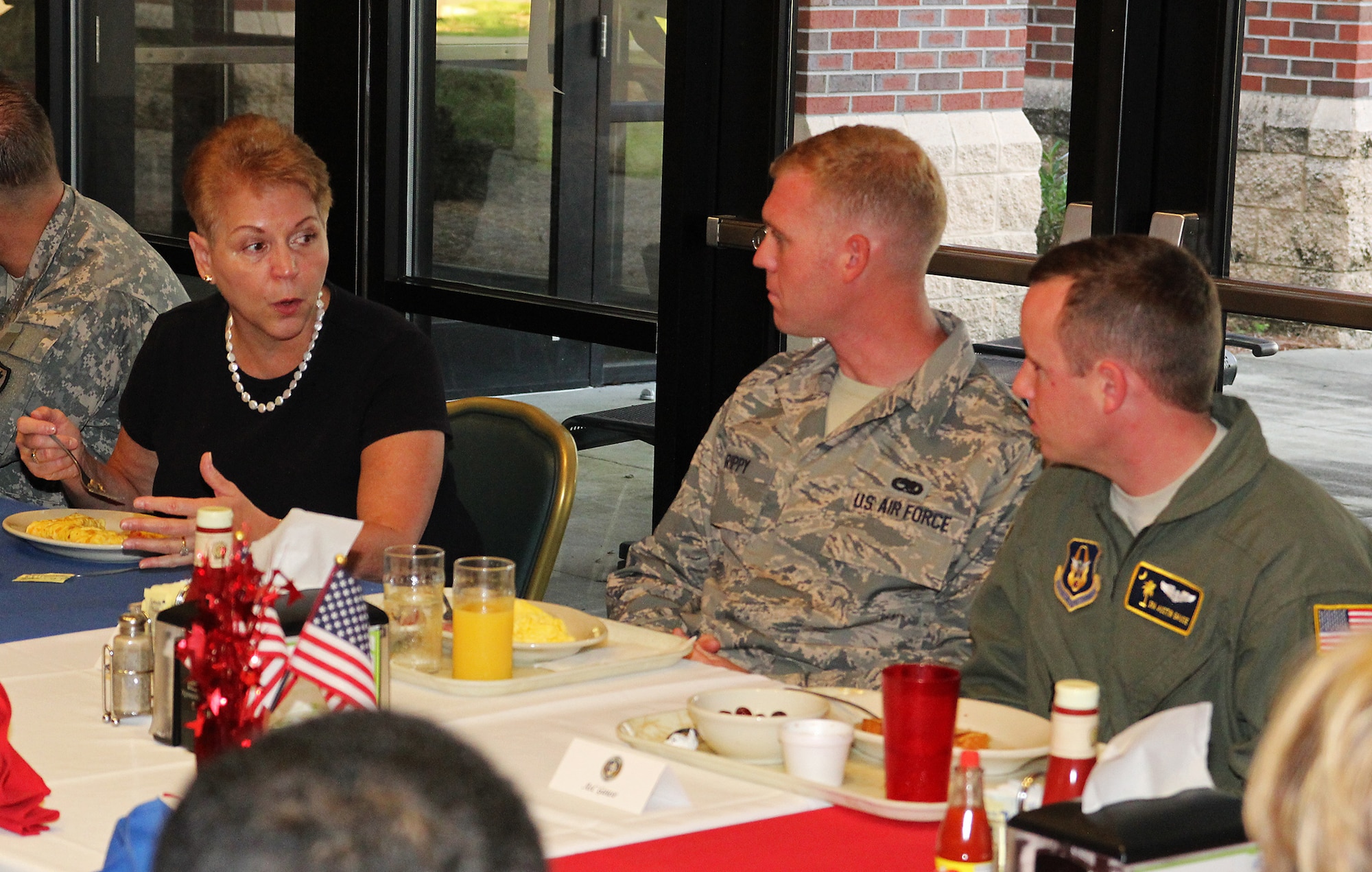 Undersecretary of Defense for Personnel and Readiness Jessica Wright chats with Staff Sgt. David Rippy, 315th Aircraft Maintenance Squadron, and Senior Airman Austin Gause, a 317 AS loadmaster during a breakfast with Airmen at Gaylor Dining Facility Saturday, Aug. 23. Wright visited Joint Base Charleston Aug. 22 and 23 to discuss resiliency and to promote sexual assault prevention and reporting with service members. (U.S. U.S. Air Force Photo / Michael Dukes)