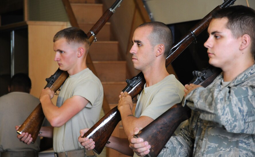 Team Mildenhall members practice rifle movements during weekly honor guard training Aug. 5, 2014, on RAF Mildenhall, England. The honor guard mainly trains in building 644 unless they are preparing for a specific event such as retreat or a firing party, when they will go train at a location where they have more space. (U.S. Air Force photo/Gina Randall/Released)