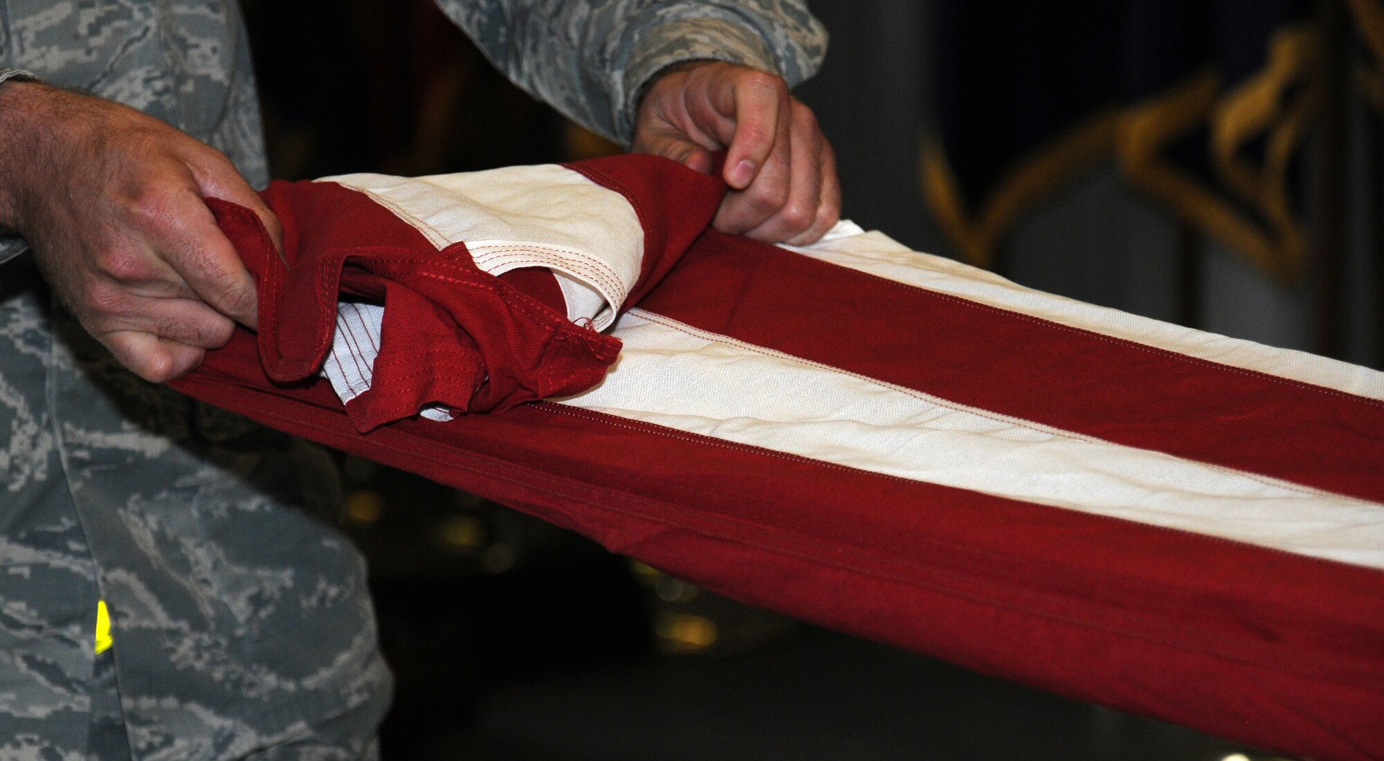 U.S. Air Force Senior Airman Jesse Dunsmore, 100th Maintenance Squadron aerospace ground equipment journeyman from Wichita Falls, Texas, practices flag-folding during weekly honor guard training Aug. 5, 2014, on RAF Mildenhall, England. The skills these Airmen learn can continue when they move to another base. Once they learn these skills, they stay with them for life. (U.S. Air Force photo/Gina Randall/Released)