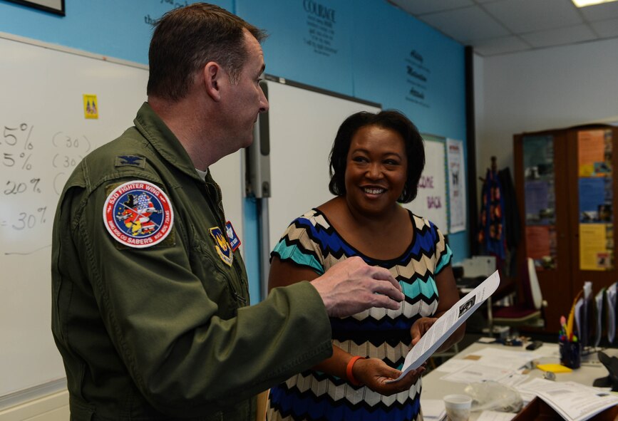 U.S. Air Force Col. Pete Bilodeau, 52nd Fighter Wing commander, talks with Beth Howard, Bitburg High School social studies teacher and native of San Antonio, during the first day of school at Bitburg Annex, Germany, Aug. 25, 2014. Bilodeau’s tour of the school was the first time he has been to the facility during his time as wing commander. (U.S. Air Force photo by Airman 1st Class Kyle Gese/Released)