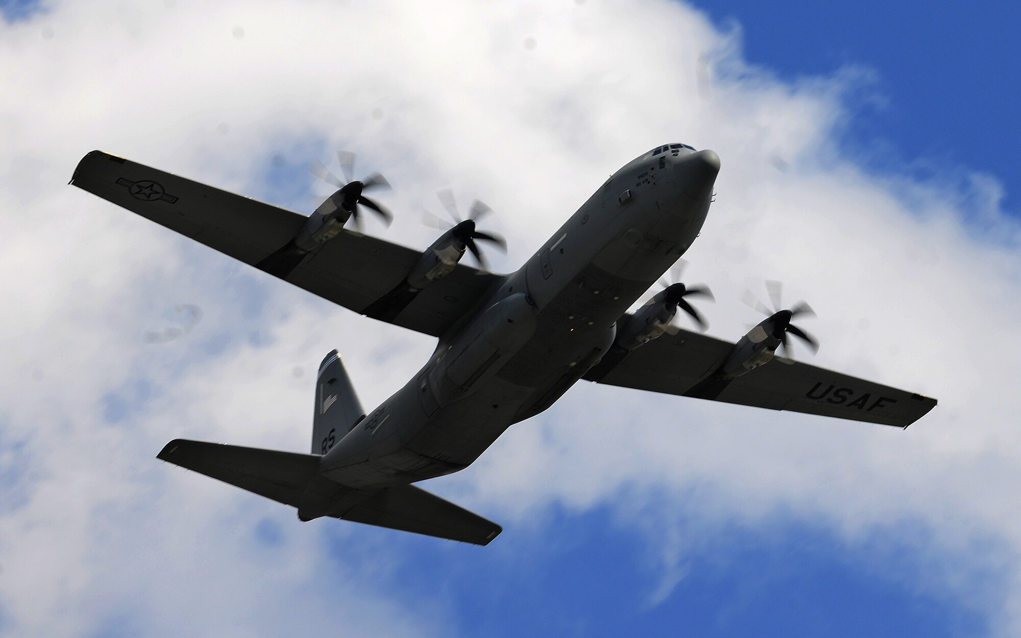 A C-130J Super Hercules flies over the flightline during an unimproved landing zone training mission at Powidz Air Base, Poland, Aug. 25, 2014. During the 60-day deployment to Poland, the aircraft were able to engage in a multitude of training opportunities in support of Operation Atlantic Resolve. (U.S. Air Force photo by Staff Sgt. Jarad A. Denton/Released)