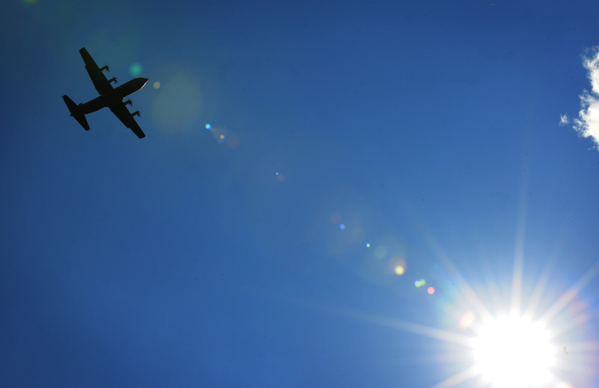A C-130J Super Hercules flies over the flightline during an unimproved landing zone training mission at Powidz Air Base, Poland, Aug. 25, 2014. During the 60-day deployment to Poland, the aircraft were able to engage in a multitude of training opportunities in support of Operation Atlantic Resolve. (U.S. Air Force photo by Staff Sgt. Jarad A. Denton/Released)