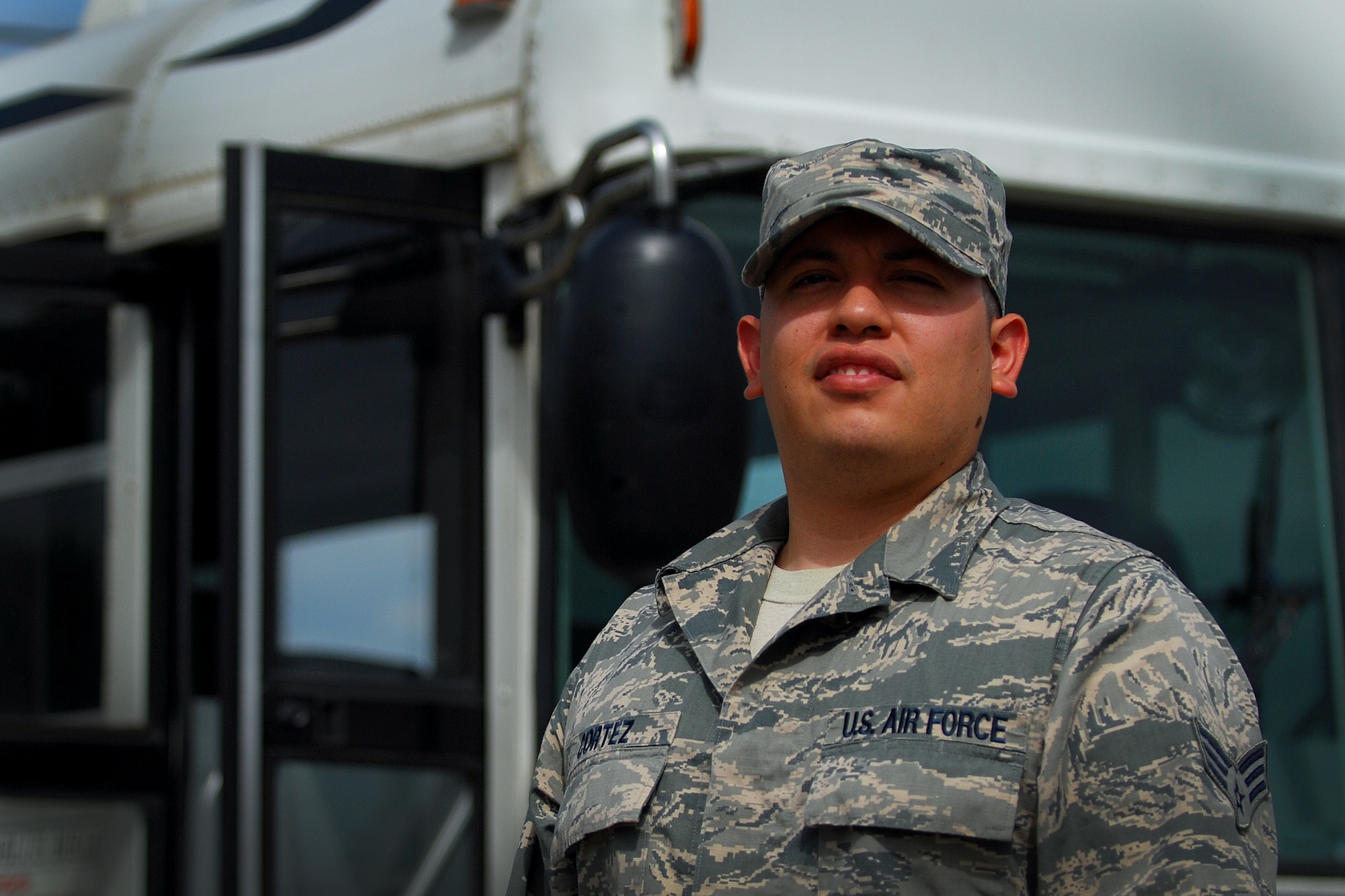 Senior Airman Jack Cortez, 374th Logistical Readiness Squadron vehicle operator, waits outside a bus at Osan Air Base, South Korea, during Ulchi Freedom Guardian, Aug. 25, 2014. Cortez, one of six vehicle operators, provided transportation services 24 hours a day during UFG. (U.S. Air Force photo by Senior Airman Racheal E. Watson/Released)