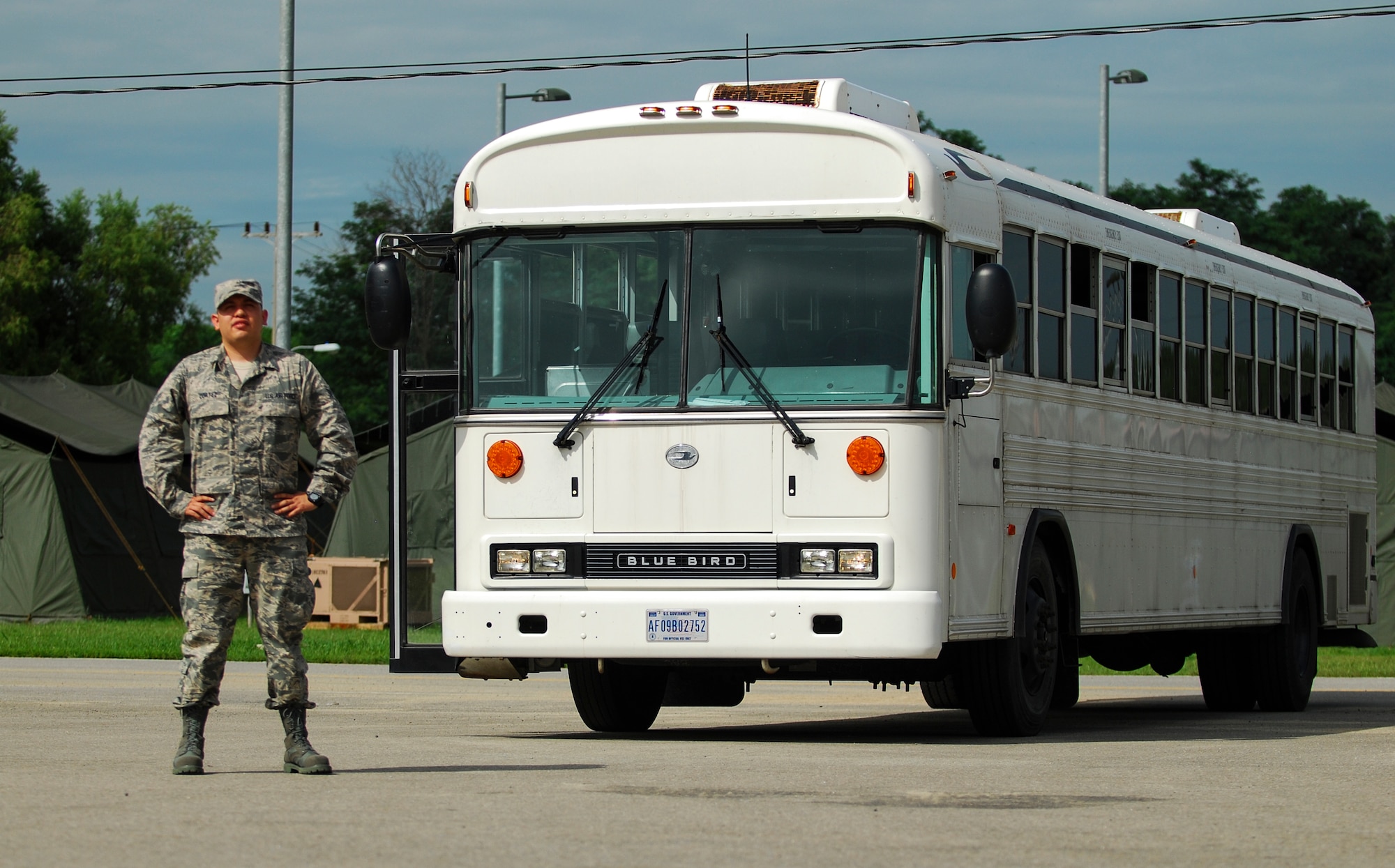 Senior Airman Jack Cortez, 374th Logistical Readiness Squadron vehicle operator, stands near his assigned 44-passenger bus at Osan Air Base, South Korea, during Ulchi Freedom Guardian, Aug. 25, 2014. Cortez, a mission support augmentee, is stationed at Yokota Air Base, Japan. (U.S. Air Force photo by Senior Airman Racheal E. Watson/Released)