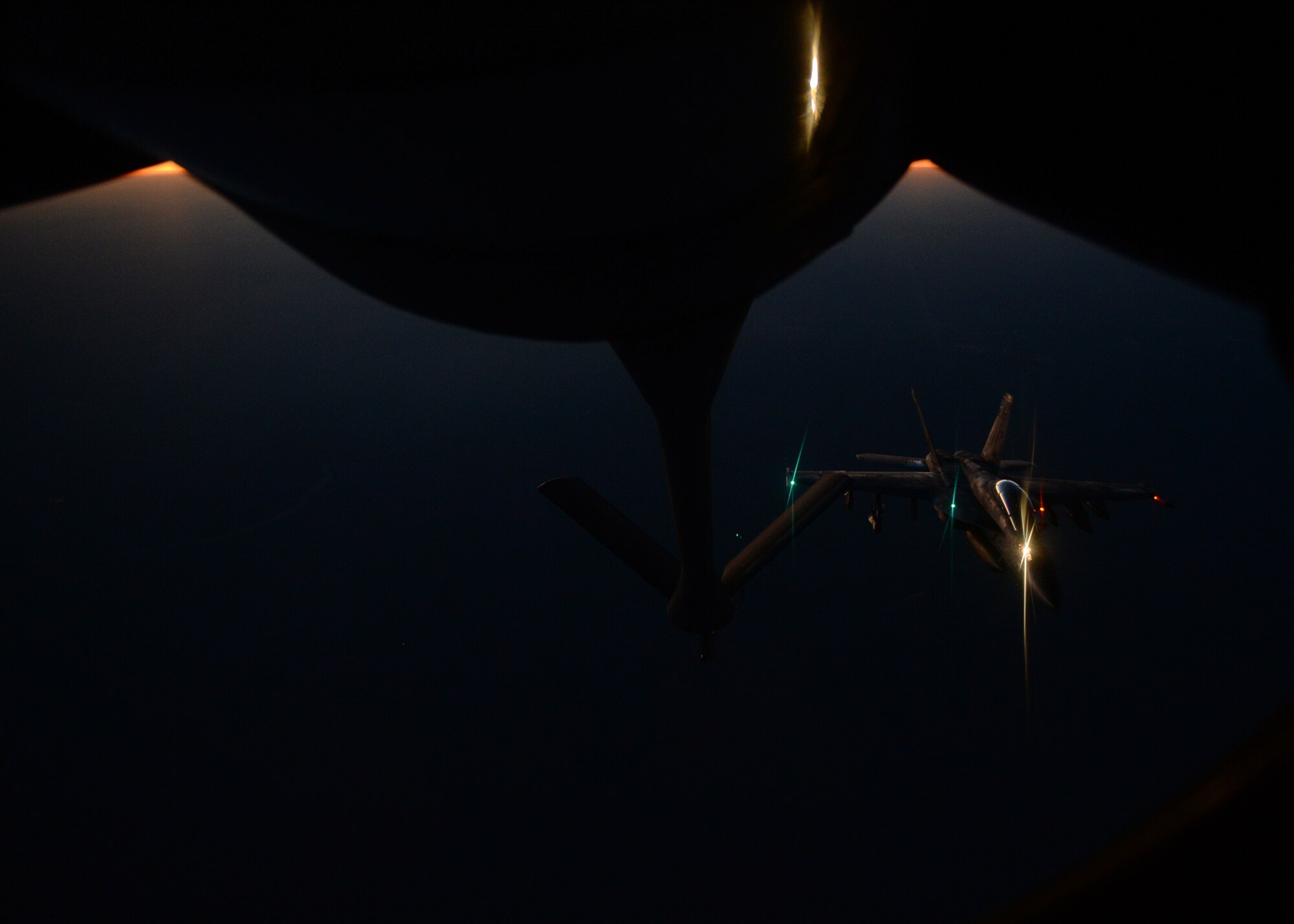 MIDDLE EAST - An U.S. fighter jet refuels from an Air Force KC-135 Stratotanker Aug. 21.  (U.S. Air Force photo by Staff Sgt. Shawn Nickel)