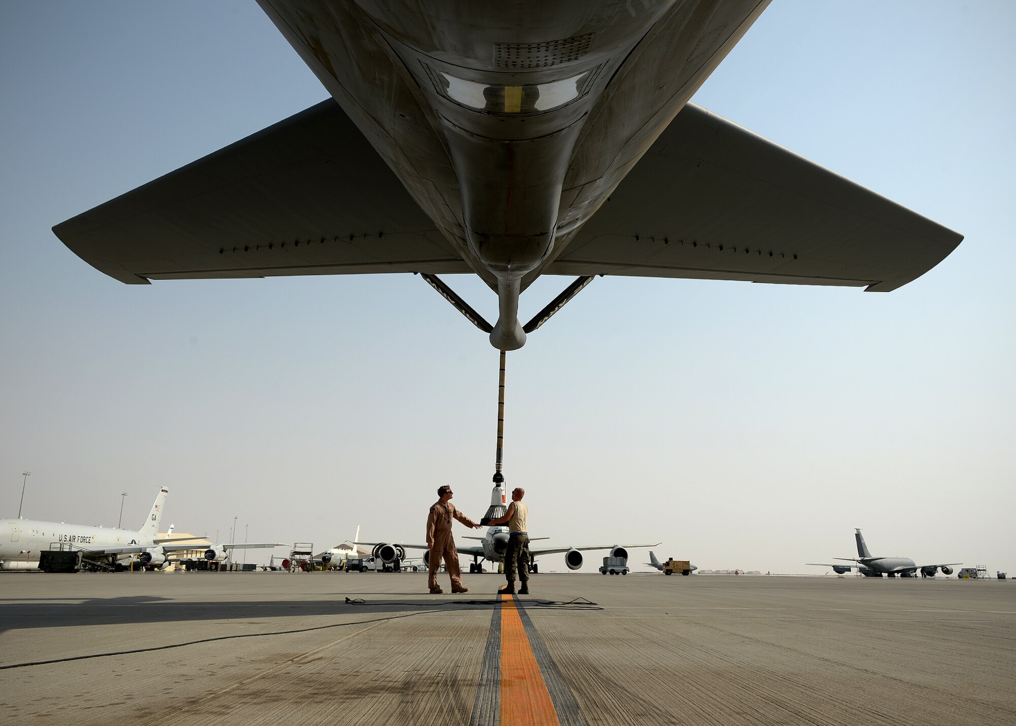 MIDDLE EAST - Air Force Capt. Ryan Christie, 340th Expeditionary Air Refueling Squadron mission commander, and a crew chief for the 340th Expeditionary Aircraft Maintenance Unit, does preflight checks on a KC-135 Stratotanker. The aircraft is fitted with a drogue boom extension to fit specific aircraft from sister services. (U.S. Air Force photo by Staff Sgt. Shawn Nickel)