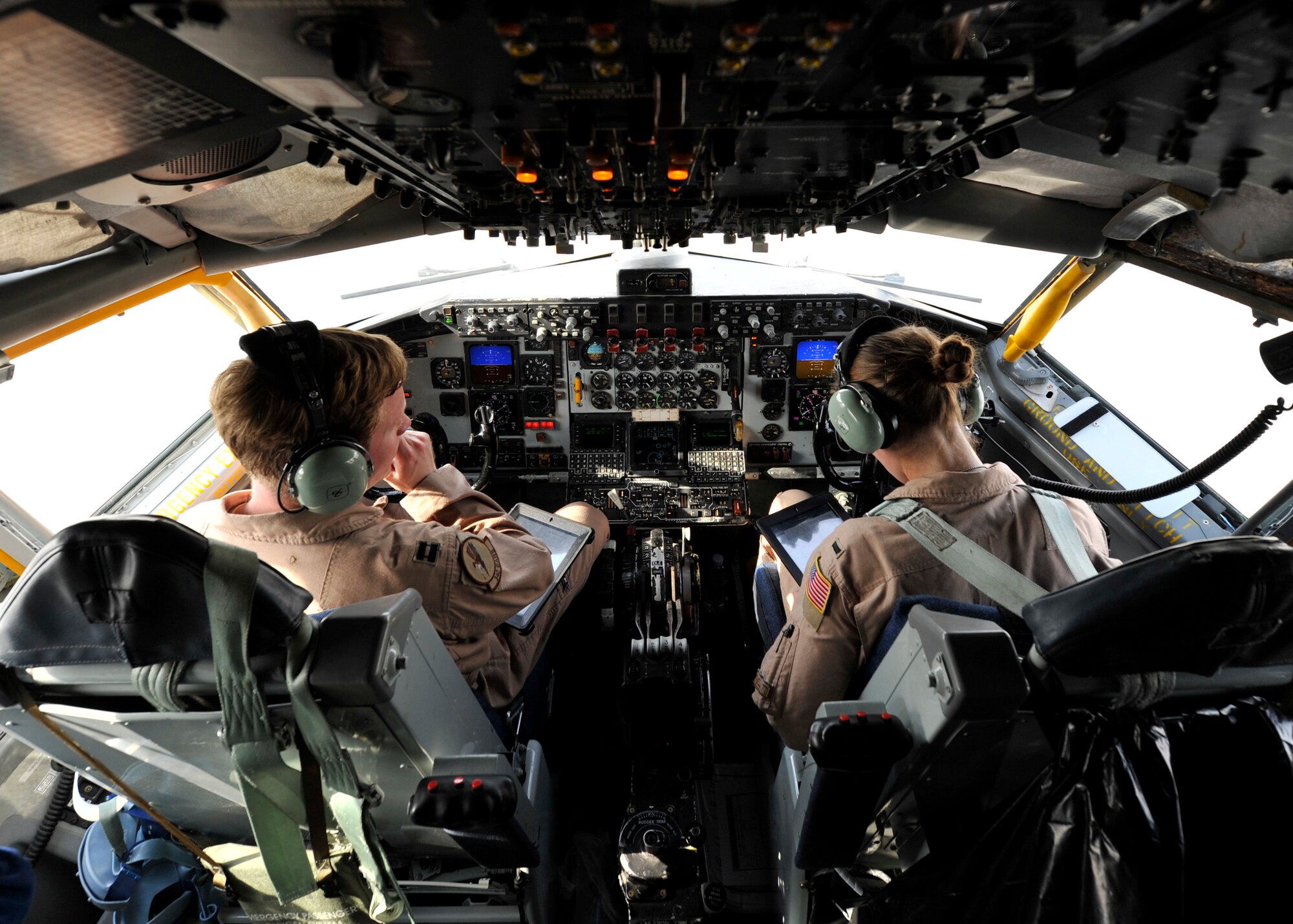 MIDDLE EAST - Capt. Ryan Christie and 1st Lt. Kaylyn Leibrand discuss approach plans during an aerial refueling mission over Northern Iraq Aug. 21. The crew provides fuel to U.S. fighter and reconnaissance aircraft that are conducting operations over Iraq. (U.S. Air Force photo by Staff Sgt. Shawn Nickel)