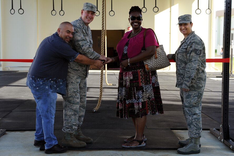 Tom Harter, 18th Force Support Squadron facilities project manager, U.S. Air Force Brig. Gen. James B. Hecker, 18th Wing commander, Verna James, 18th Civil Engineering Squadron project architect, and Tech. Sgt. Heather Consola, 18th Contracting Squadron contracting specialist, cut the ribbon at the Risner Fitness Center’s Functional Fitness Facility, or F3, grand opening ceremony on Kadena Air Base, Japan, Aug. 25, 2014. The F3 is an open air, 24-hour facility that provides additional workout space as well as functional fitness equipment such as pull-up bars, still rings and climbing ropes. (U.S. Air Force photo by Airman 1st Class Zade C. Vadnais)