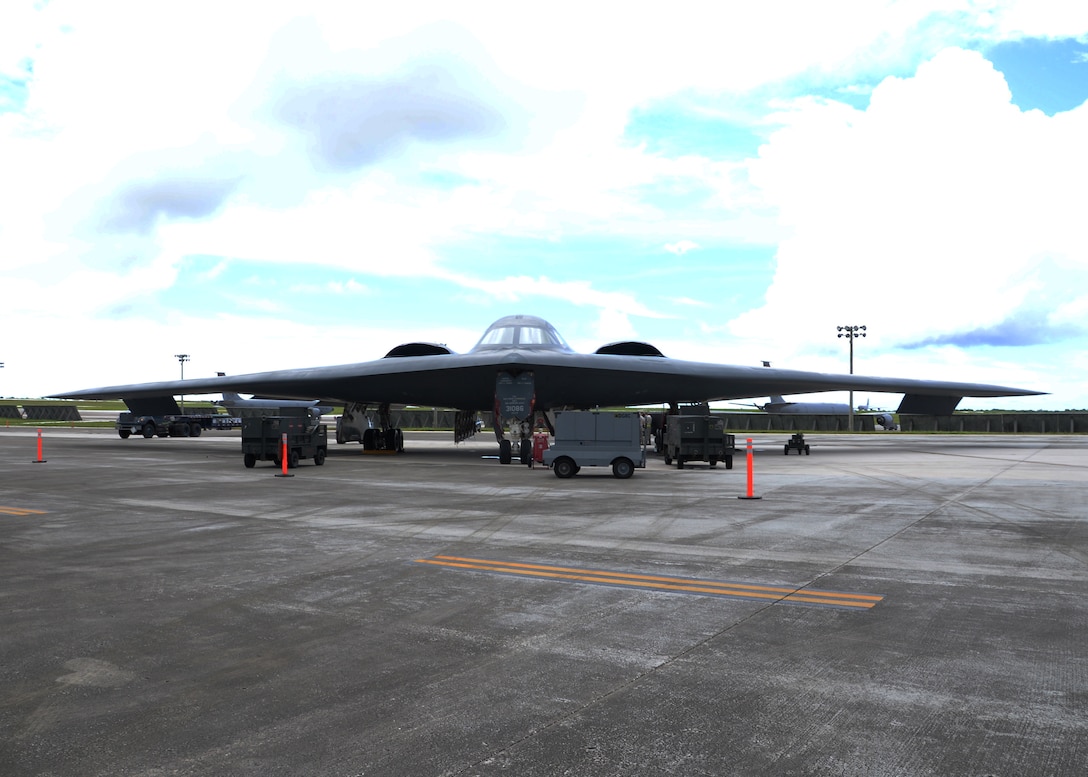 Airmen from the 509th Aircraft Maintenance Squadron work on a B-2 Spirit bomber during a deployment Aug. 22, 2014, at Andersen Air Force Base, Guam. The bombers and approximately 200 support Airmen, assigned to the 509th Bomb Wing at Whiteman Air Force Base, Mo., deployed to Guam to improve combat readiness and ensure regional stability. Bomber deployments help maintain stability in the region while allowing units to become familiar with operating in the theater. (U.S. Air Force photo/Senior Airman Cierra Presentado)
