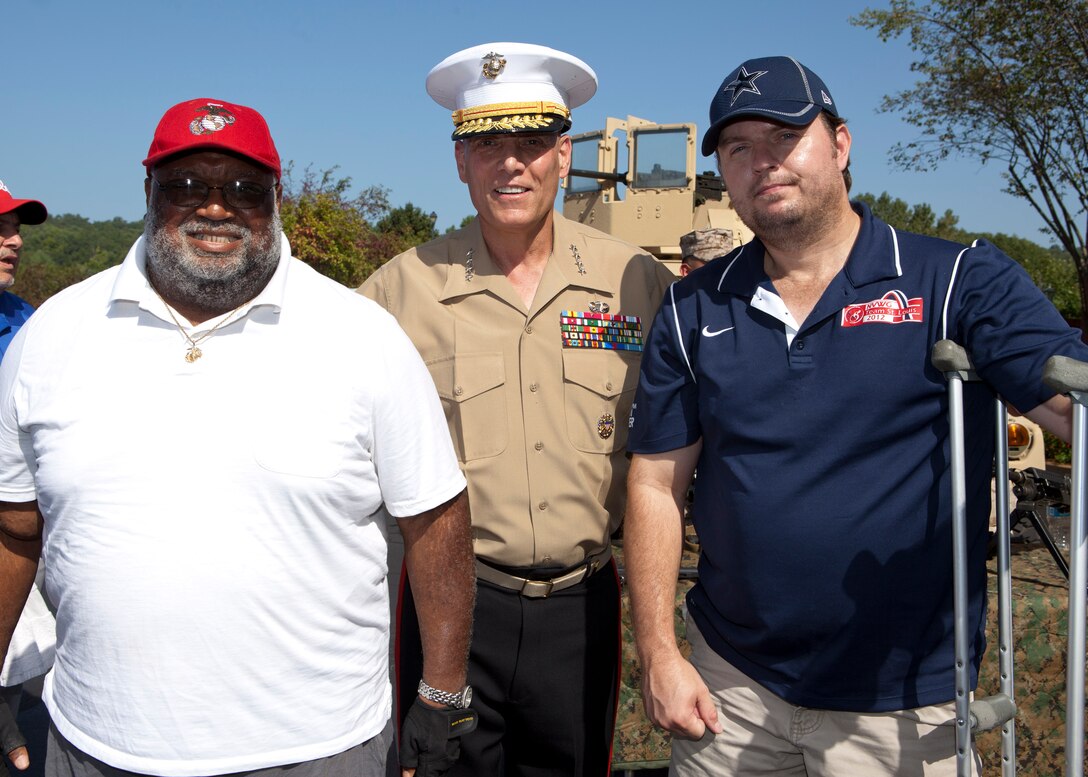 The Assistant Commandant of the Marine Corps, Gen. John M. Paxton, Jr., poses for a photo with guests participating in the Missouri Friends of Injured Marines Golf Tourney held at St. Albans Country Club, St. Albans, Mo., Aug. 24, 2014. (U.S. Marine Corps photo by Cpl. Tia Dufour/Released)