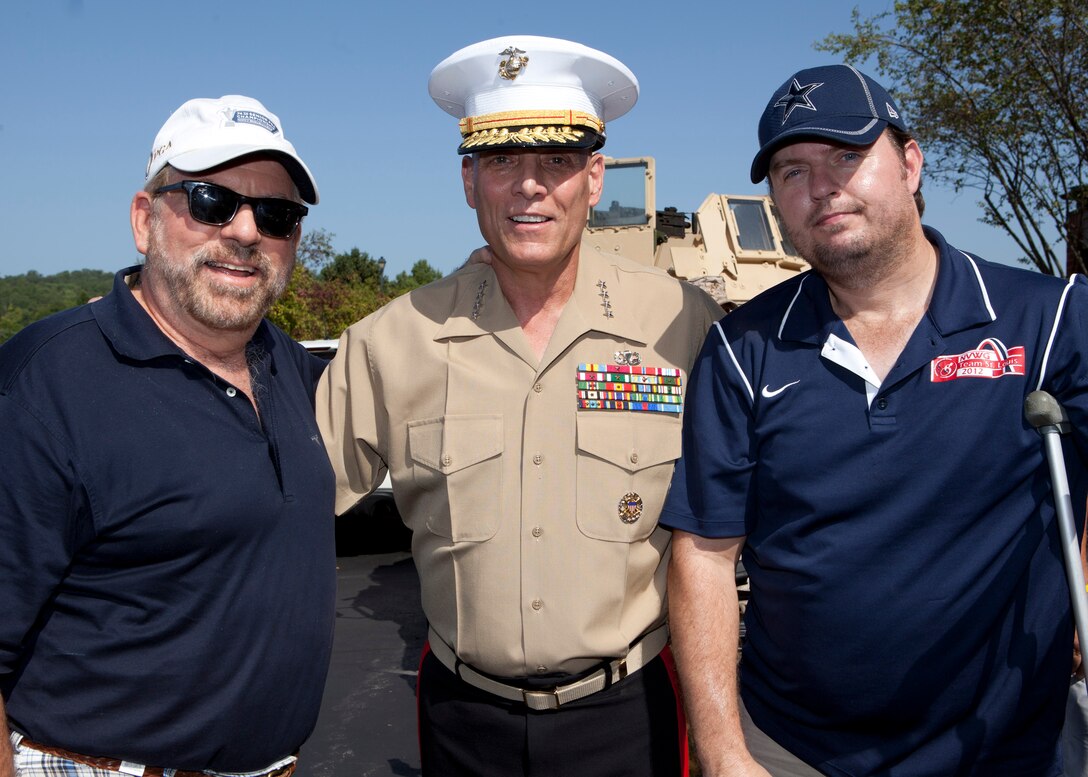The Assistant Commandant of the Marine Corps, Gen. John M. Paxton, Jr., poses for a photo with guests participating in the Missouri Friends of Injured Marines Golf Tourney held at St. Albans Country Club, St. Albans, Mo., Aug. 24, 2014. (U.S. Marine Corps photo by Cpl. Tia Dufour/Released)