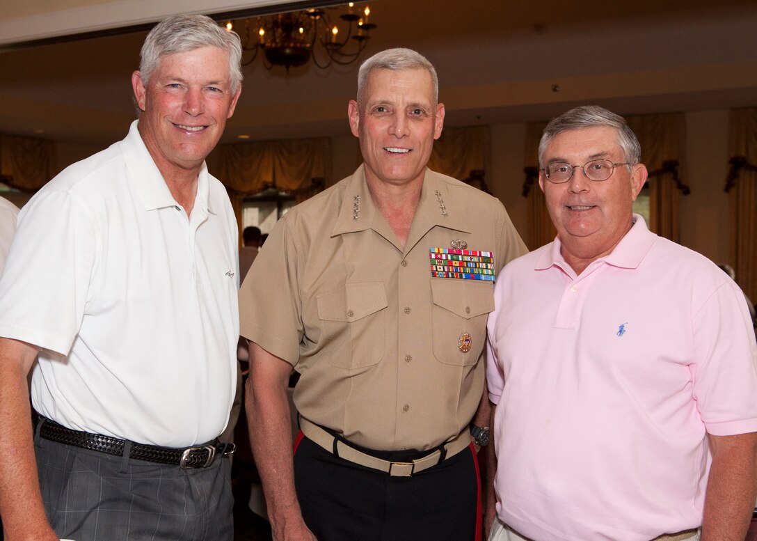 The Assistant Commandant of the Marine Corps, Gen. John M. Paxton, Jr., poses for a photo with guests participating in the Missouri Friends of Injured Marines Golf Tourney held at St. Albans Country Club, St. Albans, Mo., Aug. 24, 2014. (U.S. Marine Corps photo by Cpl. Tia Dufour/Released)