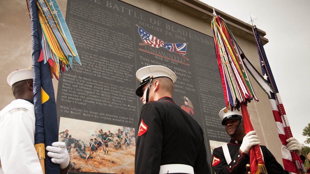 Marines and a sailor, with a sea services color guard, observe the “Undaunted in Battle” memorial in Bladensburg, Maryland Aug. 23, 2014. The monument was dedicated as a part of the 200 Year Commemoration of the Battle of Bladensburg.
