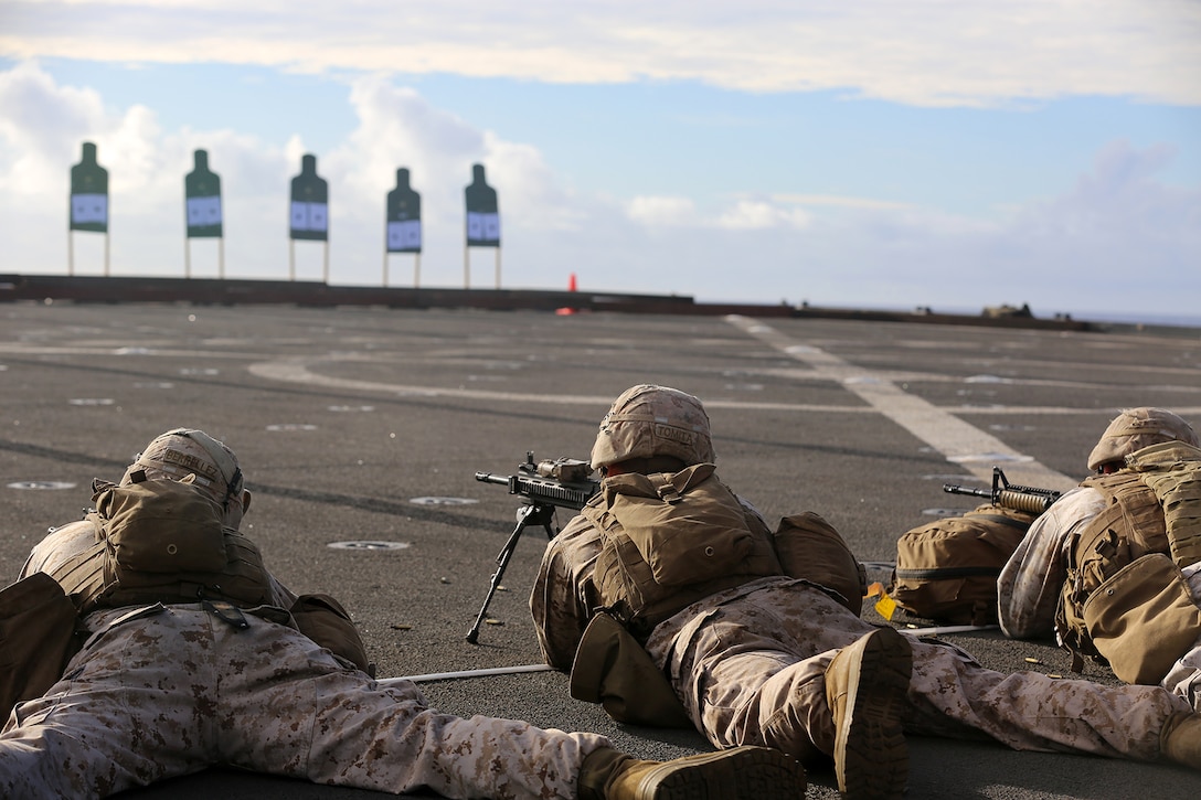 Marines with Echo Company, Battalion Landing Team 2nd Battalion, 1st Marines, 11th Marine Expeditionary Unit, conduct a small-arms shoot on the flight deck of the USS Comstock during their deployment Aug. 18. The 11th MEU and Makin Island Amphibious Ready Group are deployed to the U.S. 7th Fleet area of operations as a sea-based, expeditionary crisis response force capable of conducting amphibious missions across the full range of military operations. (U.S. Marine Corps photo by Sgt. Melissa Wenger/Released)