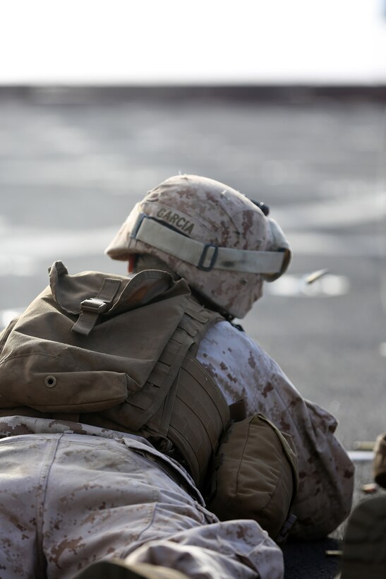 A Marine with Echo Company, Battalion Landing Team 2nd Battalion, 1st Marines, 11th Marine Expeditionary Unit, engages a target during a small-arms shoot on the flight deck of the USS Comstock during their deployment Aug. 18. The 11th MEU and Makin Island Amphibious Ready Group are deployed to the U.S. 7th Fleet area of operations as a sea-based, expeditionary crisis response force capable of conducting amphibious missions across the full range of military operations. (U.S. Marine Corps photo by Sgt. Melissa Wenger/Released)
