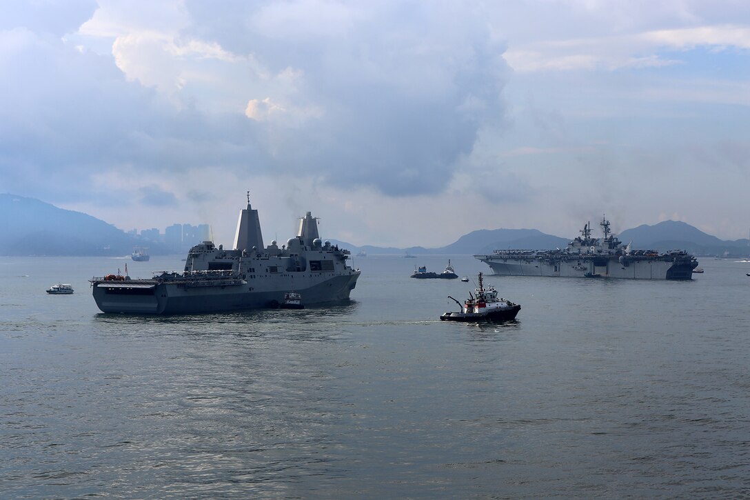The USS San Diego, left, and USS Makin Island, both embarked with Marines and sailors from the11th Marine Expeditionary Unit, remain anchored off the coast of Hong Kong, Aug. 23. The 11th MEU and Makin Island Amphibious Ready Group are deployed to the U.S. 7th Fleet area of operations as a sea-based, expeditionary crisis response force capable of conducting amphibious missions across the full range of military operations. (U.S. Marine Corps photo by Sgt. Melissa Wenger/Released)