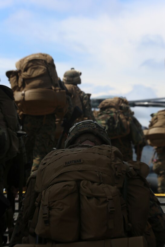 Marines with the 11th Marine Expeditionary Unit walk up a ramp to board a CH-53E Super Stallion with Marine Medium Tiltrotor Squadron 163 (Reinforced), 11th MEU, on the flight deck of the USS Comstock  Aug. 25. The 11th MEU and Makin Island Amphibious Ready Group are deployed to the U.S. 7th Fleet area of operations as a sea-based, expeditionary crisis response force capable of conducting amphibious missions across the full range of military operations. (U.S. Marine Corps photo by Sgt. Melissa Wenger/Released) 