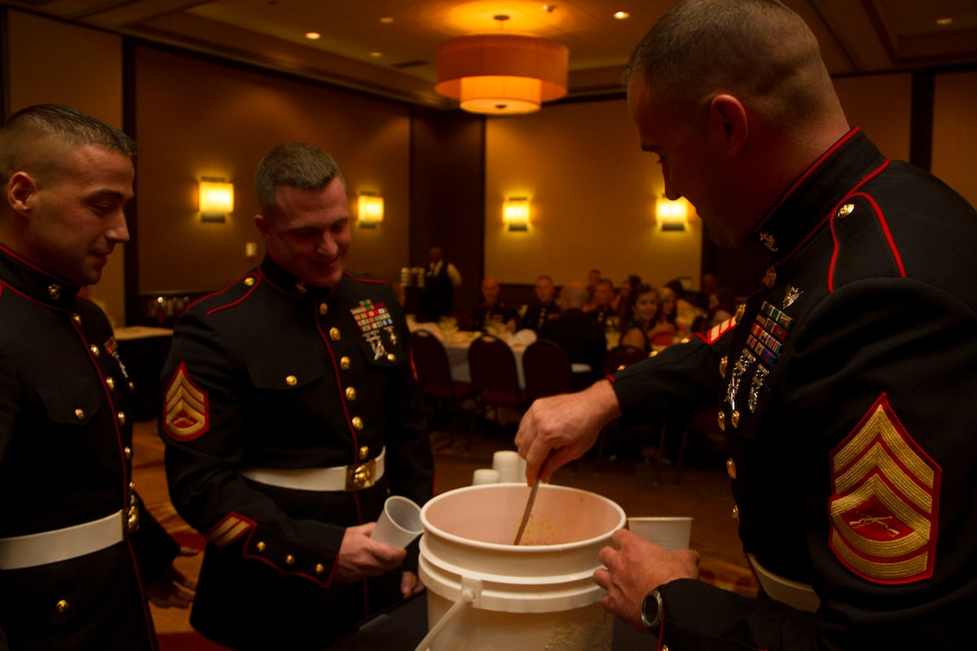 Staff Sgt. Paul Miller III, SNCOIC of Recruiting Substation Fond du Lac, Staff Sgt. Peter Vargo, SNCOIC of Recruiting Substation Appleton, and Gunnery Sgt. Jeremy Simms, Operations Chief of Recruiting Station Milwaukee, (left to right) prepare to drink from the “grog” during RS Milwaukee’s first Dining Out, Aug. 20 in Brown Deer, Wis.  The “grog” is a less than appetizing mix of mystery ingredients that Marines may have to drink from if they are caught violating the “Rules of the Mess.”