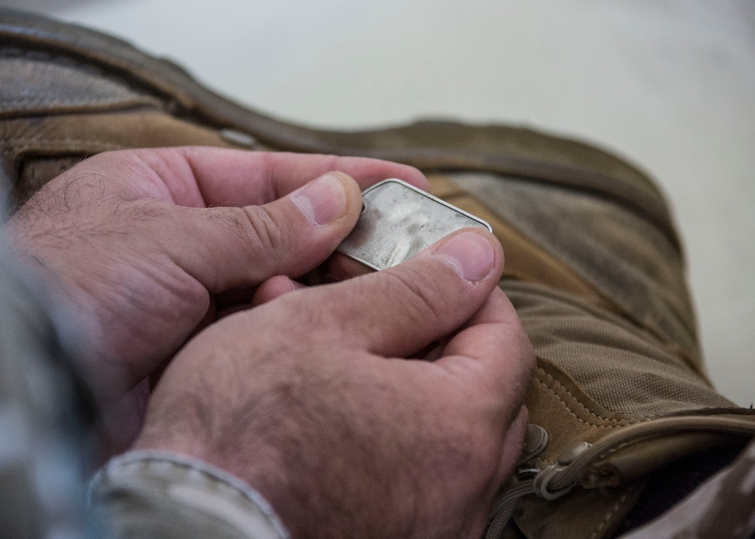 Sgt. 1st Class Matevz Scheicher, member of the Slovenian Army, reads a U.S. Marine dog tag during the Mortuary Affairs class as part of Immediate Response 2014 here, Aug. 21, 2014. While the PRP Marines are already trained to know the process, the Slovenian soldiers are not familiar with how the U.S. conducts PRP.