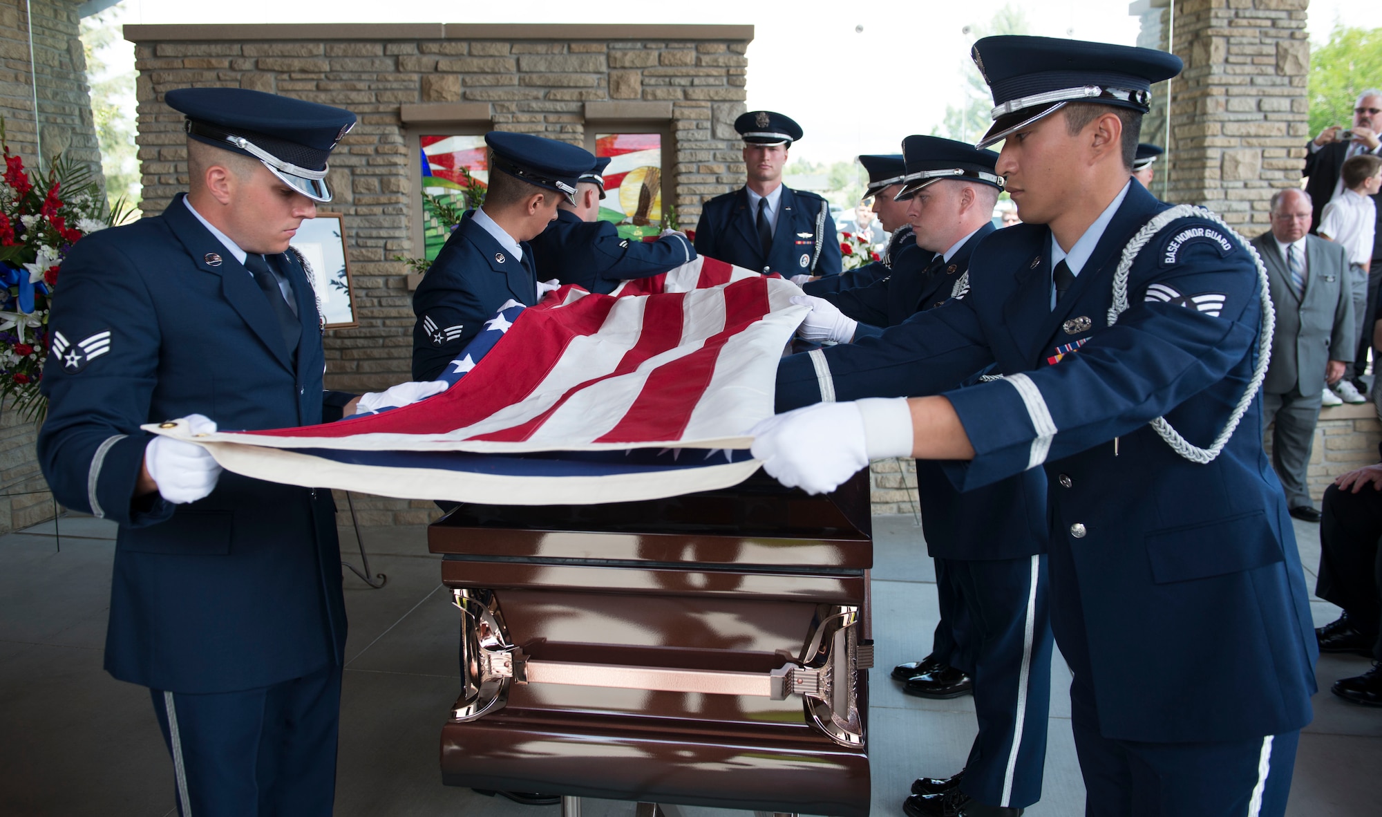 Members of the Mountain Home Air Force Base Honor Guard ceremoniously fold the flag during the interment ceremony for the late Col. Bernard Fisher, a Medal of Honor recipient, Aug. 25, 2014, at Idaho State Veterans Cemetery, Boise, Idaho. He was presented the Medal of Honor for risking his own life while going above and beyond the call of duty to save a fellow pilot who had been shot down at A Shau Air Base, Vietnam during the battle of A Shau Valley, March 10, 1966. (U.S. Air Force photo/Airman 1st Class Malissa Lott)