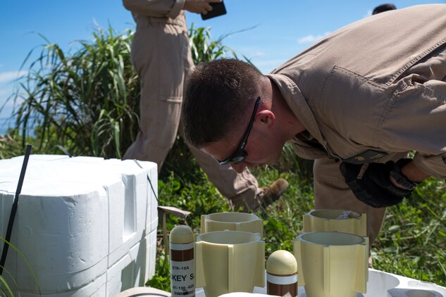 Lance Cpl. Zachary Swisher, ordnanceman with Marine Aerial Refueler Squadron 152, inspects a GTR-18 missile, better known as a "Smokey SAM," during a threat reaction evolution on an island outside of Okinawa, Japan, Aug. 26, 2014. The threat reaction evolution is a chance for pilots to stay up to date on their qualifications while keeping an alert and aware mindset for any arising combat scenario.